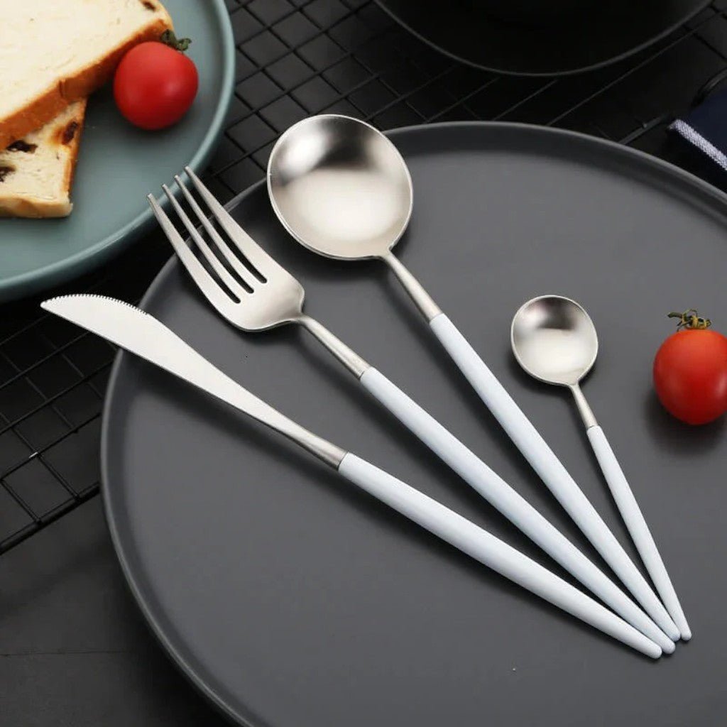 White and silver cutlery place setting on a plate