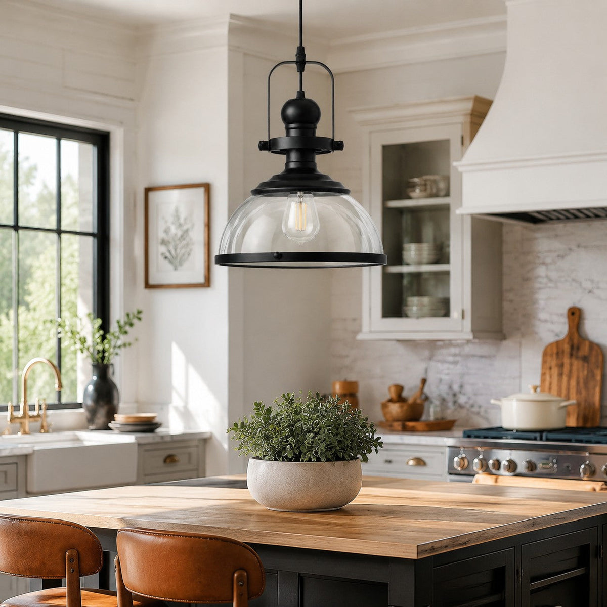 Clear glass dome pendant light above a butcher block kitchen island