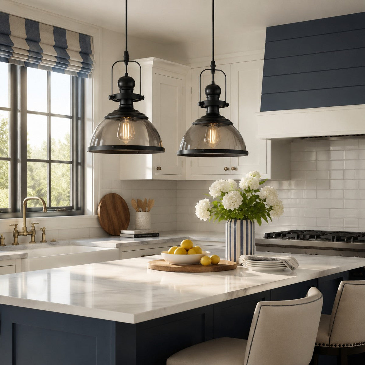 Pair of smoked glass dome pendant lights over a white marble kitchen island