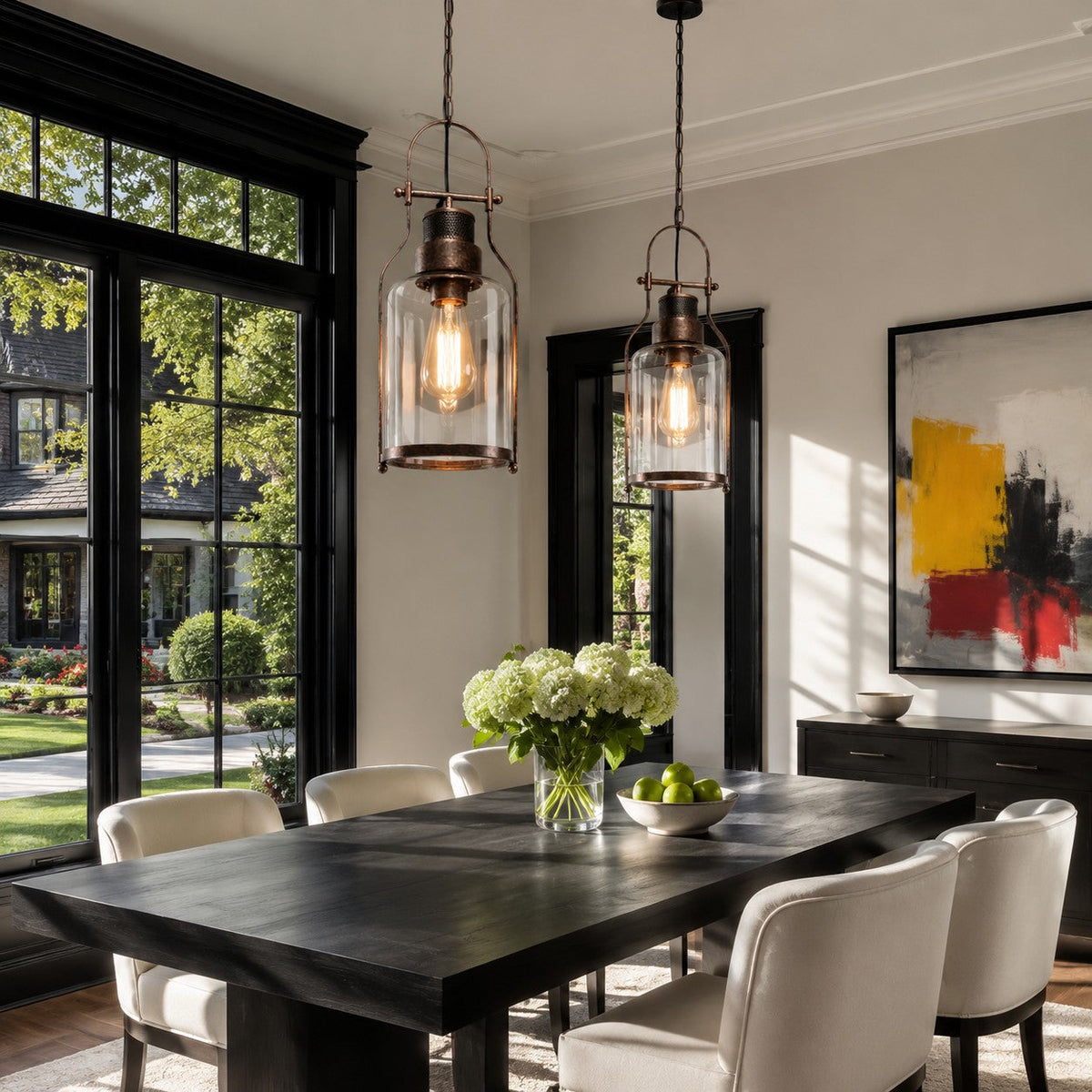 Black glass jar pendants over a dark dining table by French doors