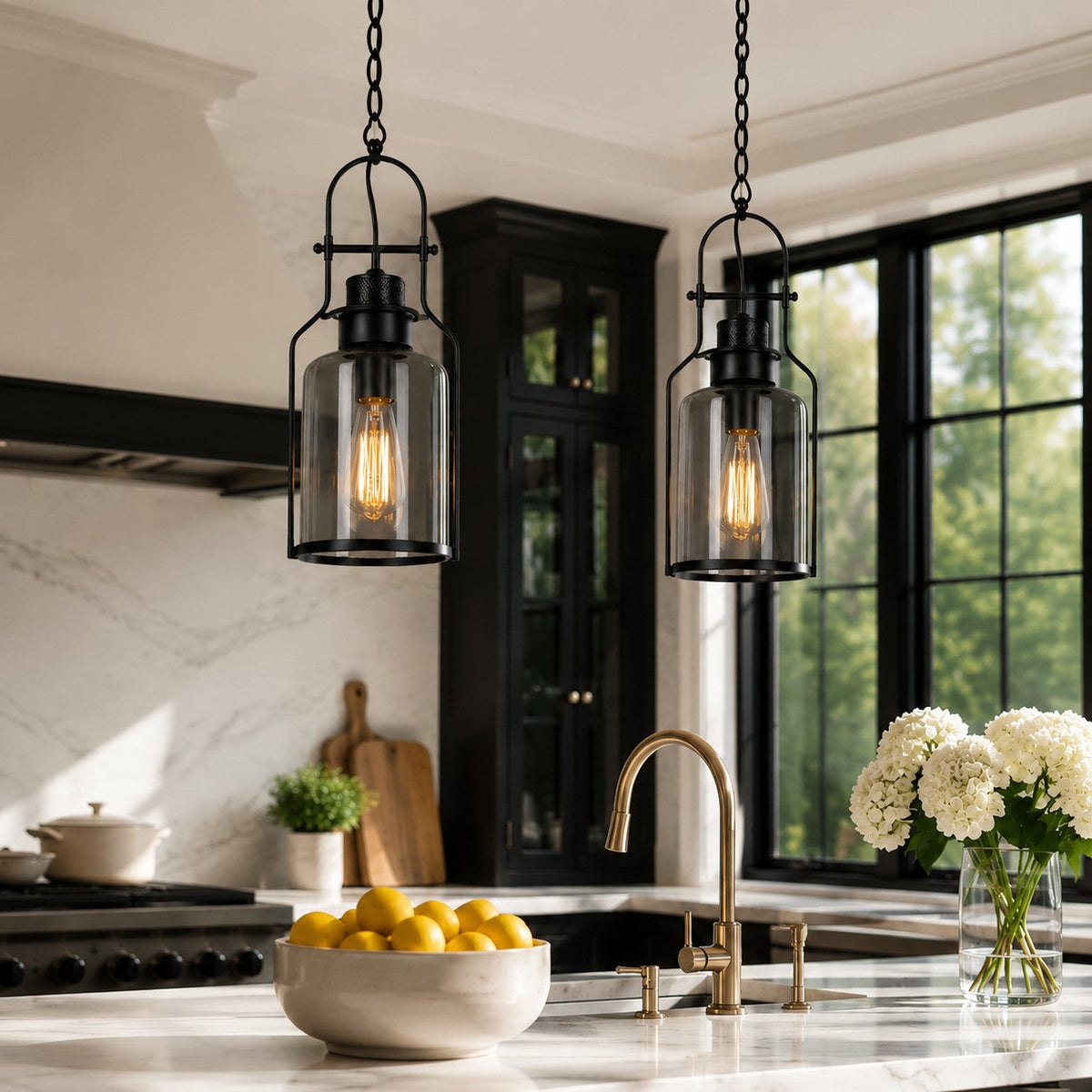 Pair of black glass jar pendants over a marble kitchen island