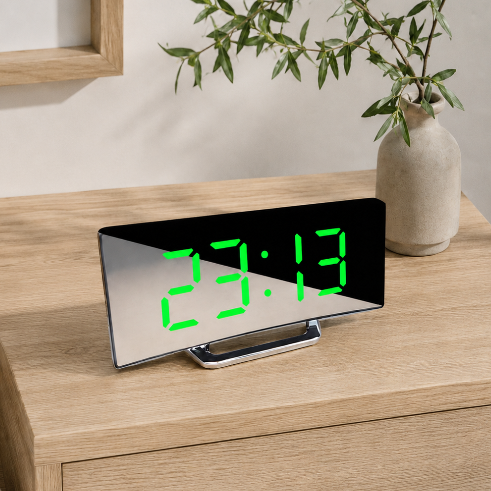 Arco Notte LED digital alarm clock with green display on a bright shelf
