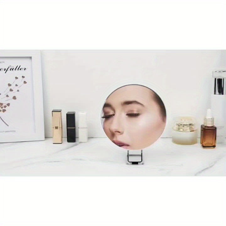Chiara Vista magnifying makeup mirror with suction cup, held in hand