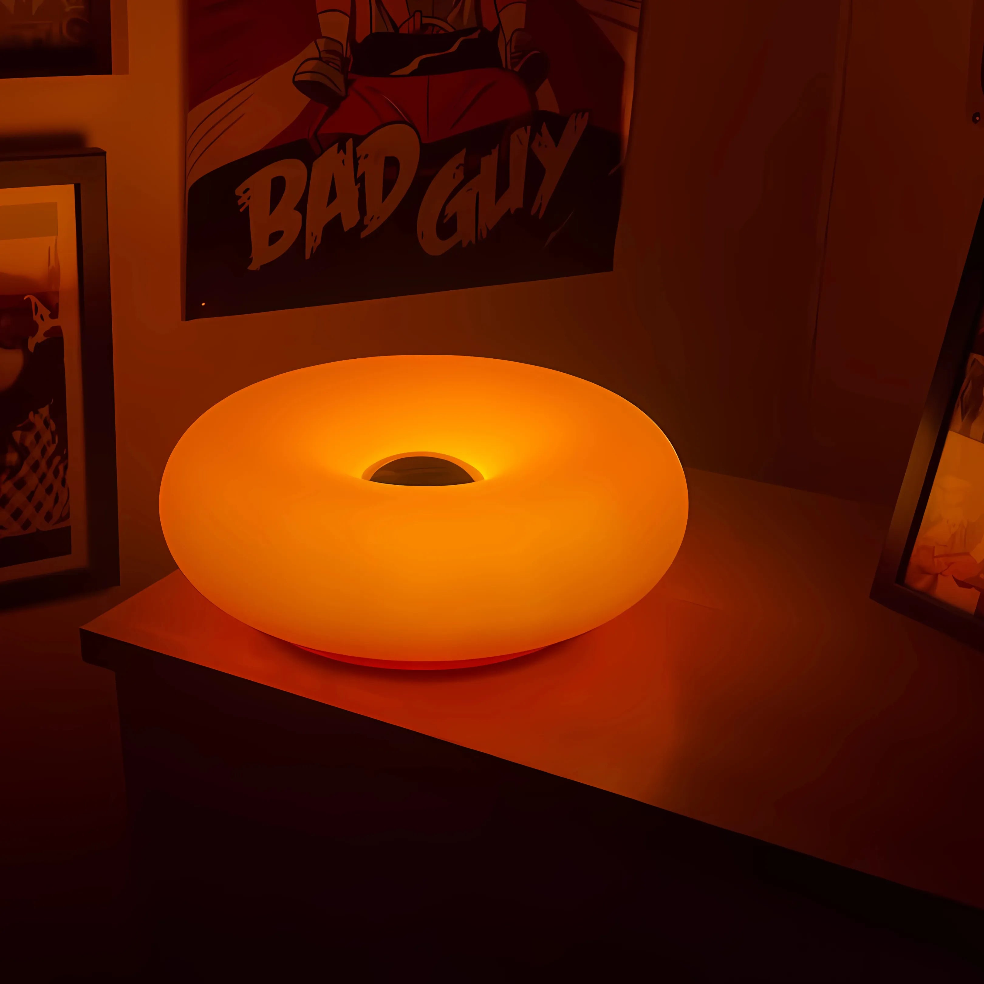 Sole Ambrato amber donut lamp glowing warm on a console