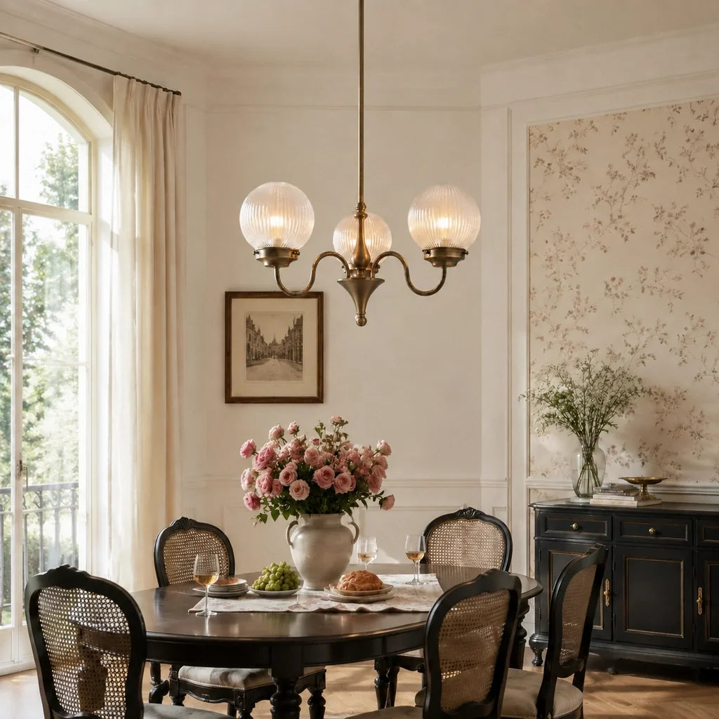 Antique brass globe chandelier over a dining table