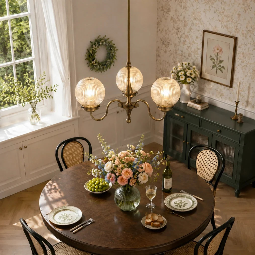 Antique brass globe chandelier above a round dining table
