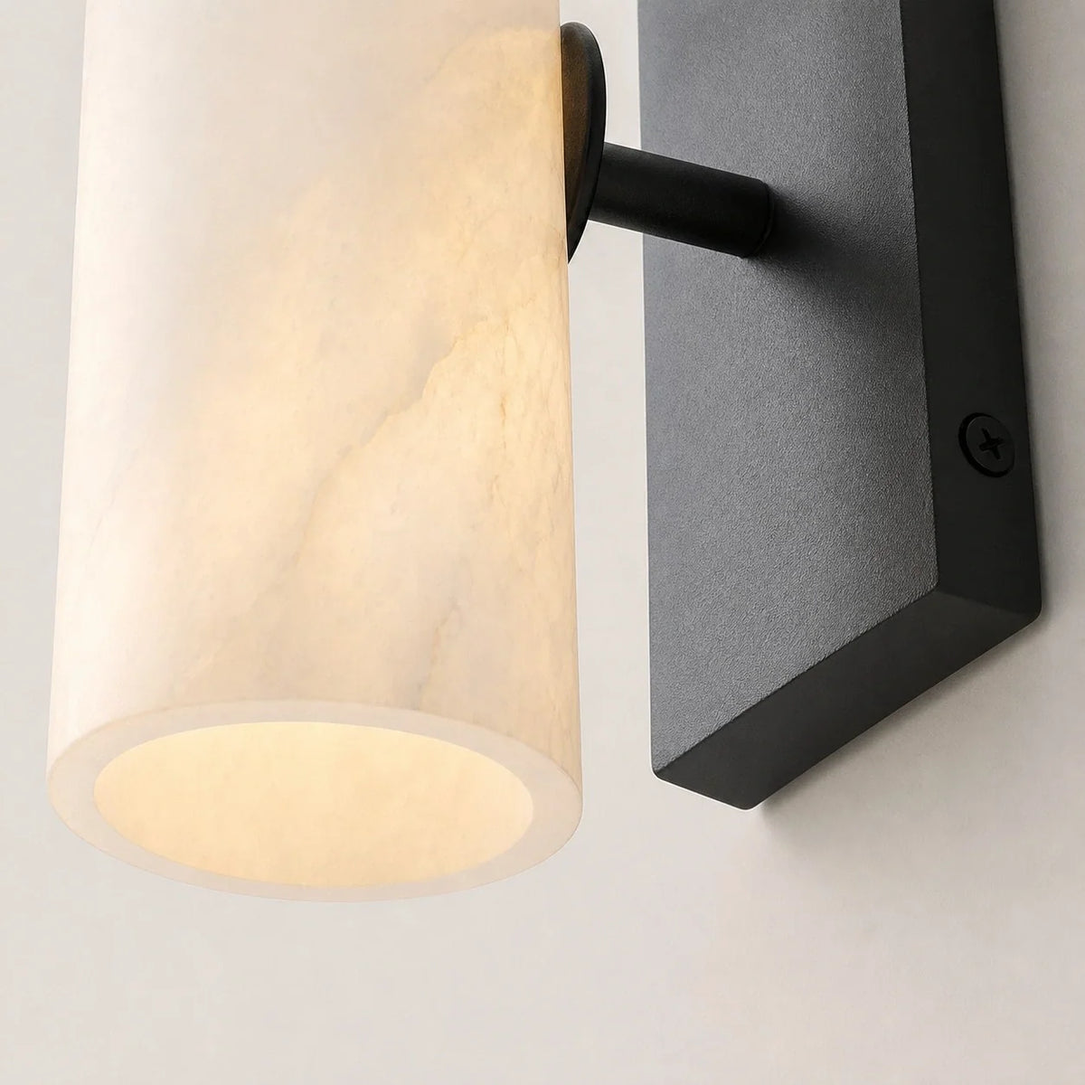 Alabaster shade and black arm detail of the Colonna Velata sconce