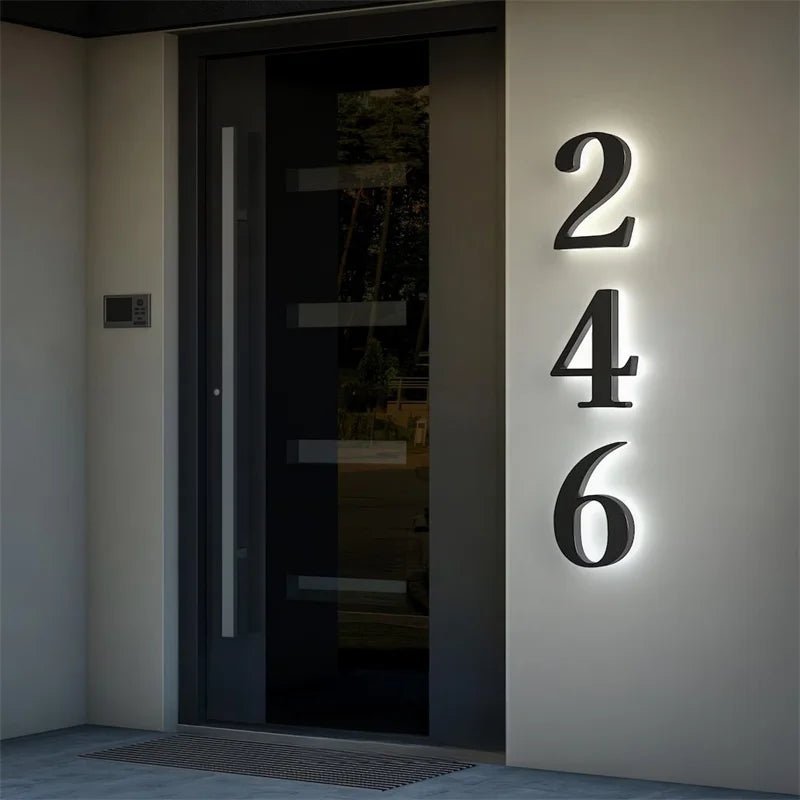 Illuminated house numbers 246 beside a modern front door