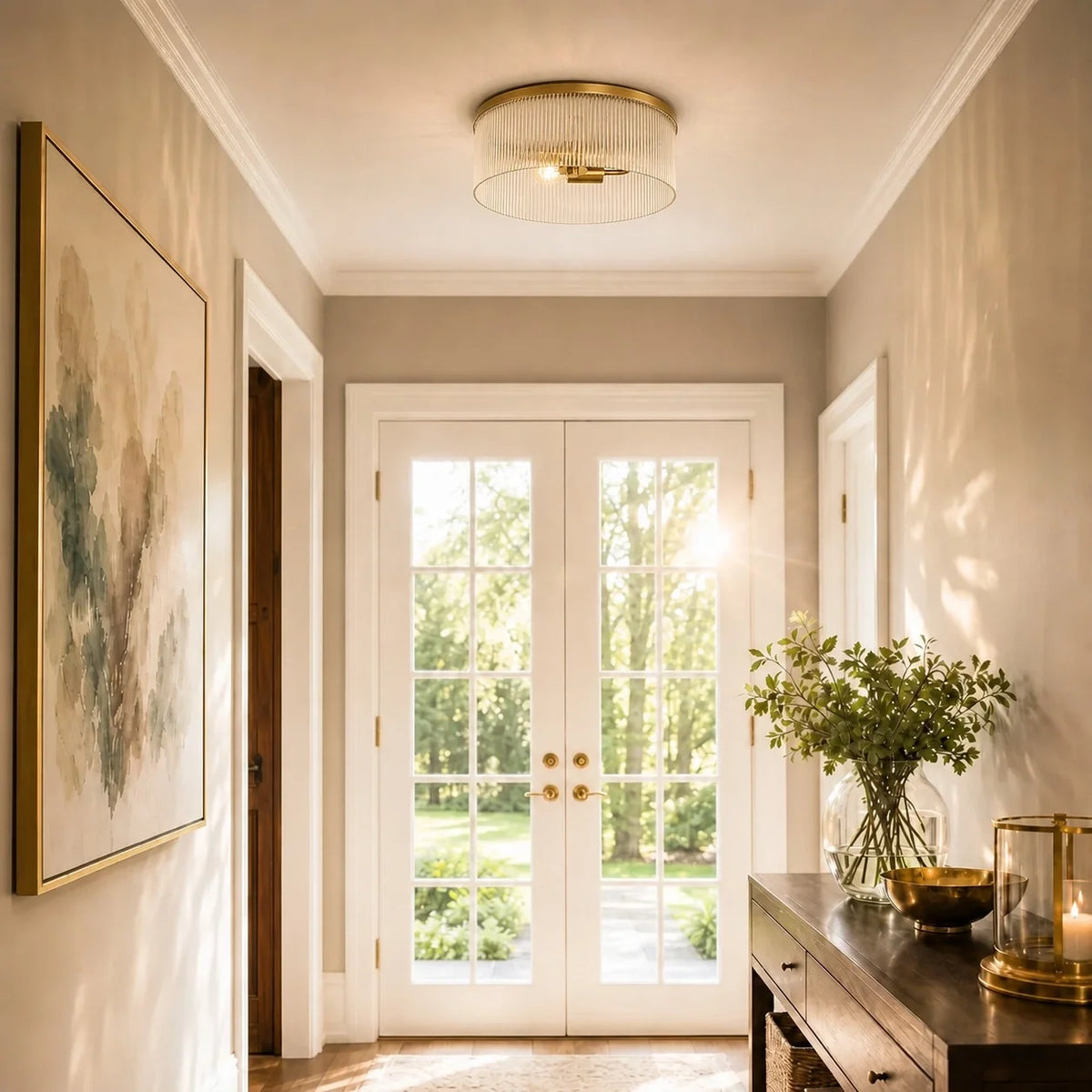Tumbled brass ribbed glass flush mount in a bright entry hall with French doors