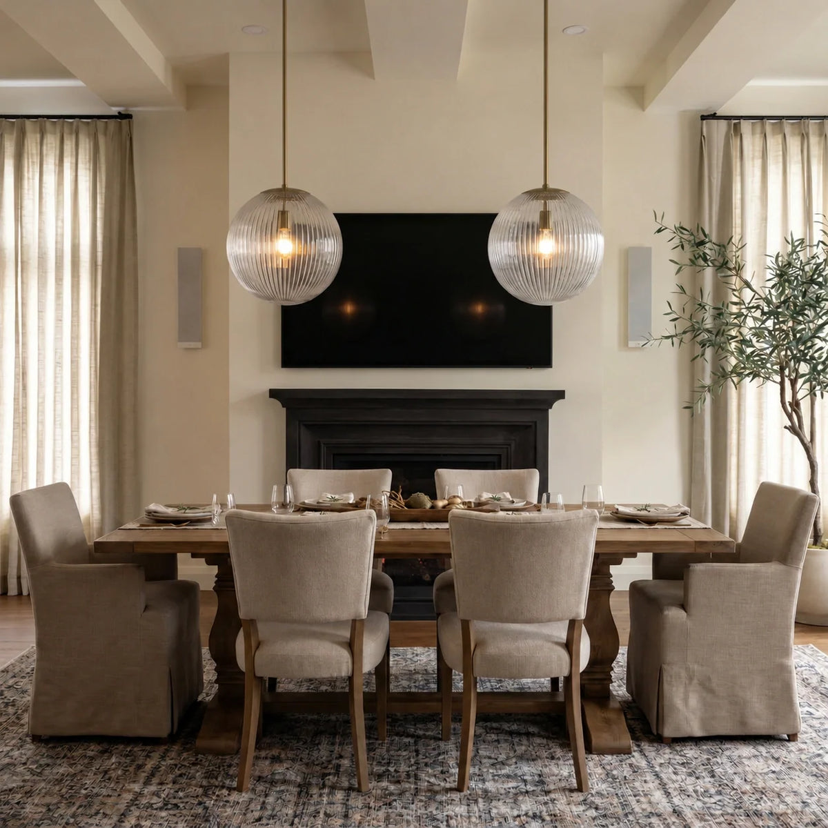 Pair of brass ribbed glass globe pendants over a dining table by the fireplace