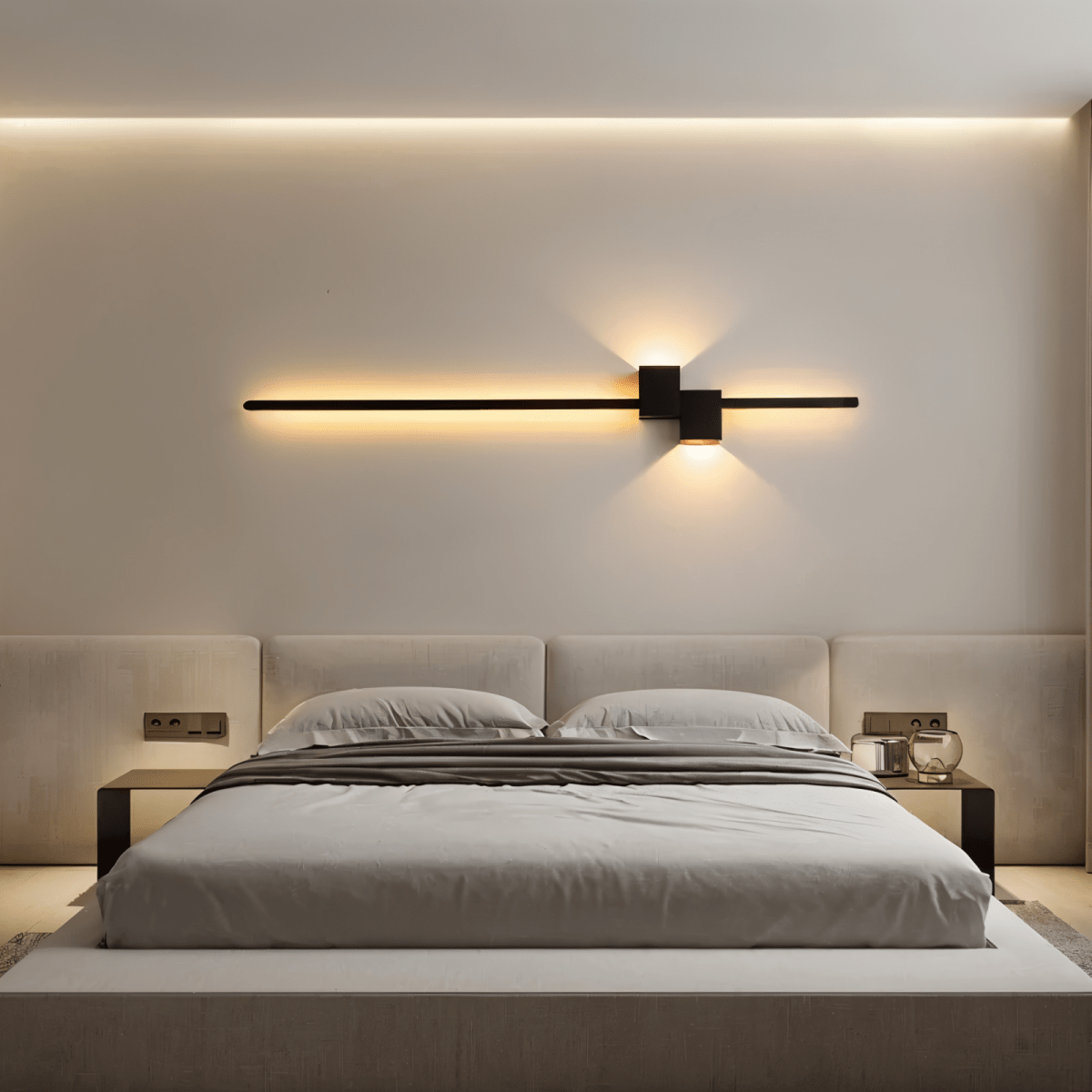 Black linear LED wall light above a bed, warm indirect glow