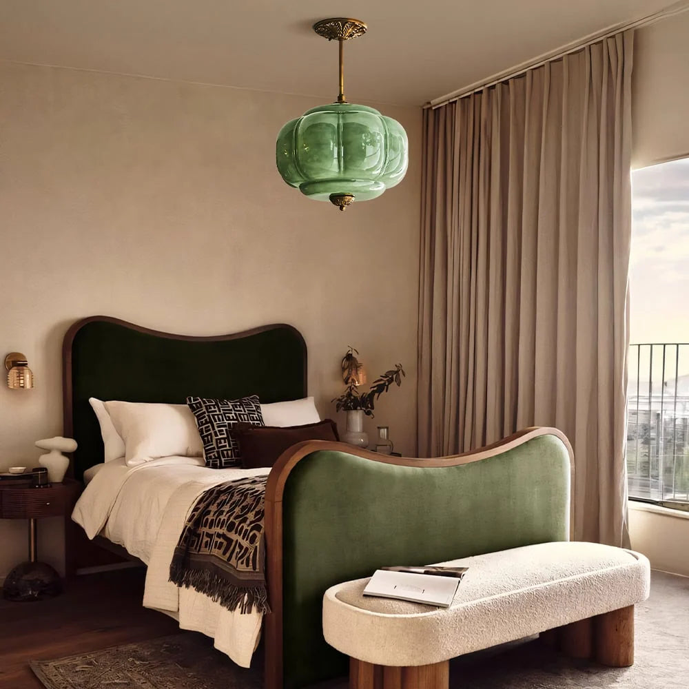 Green fluted glass semi-flush pendant in a moody bedroom with a green velvet bed