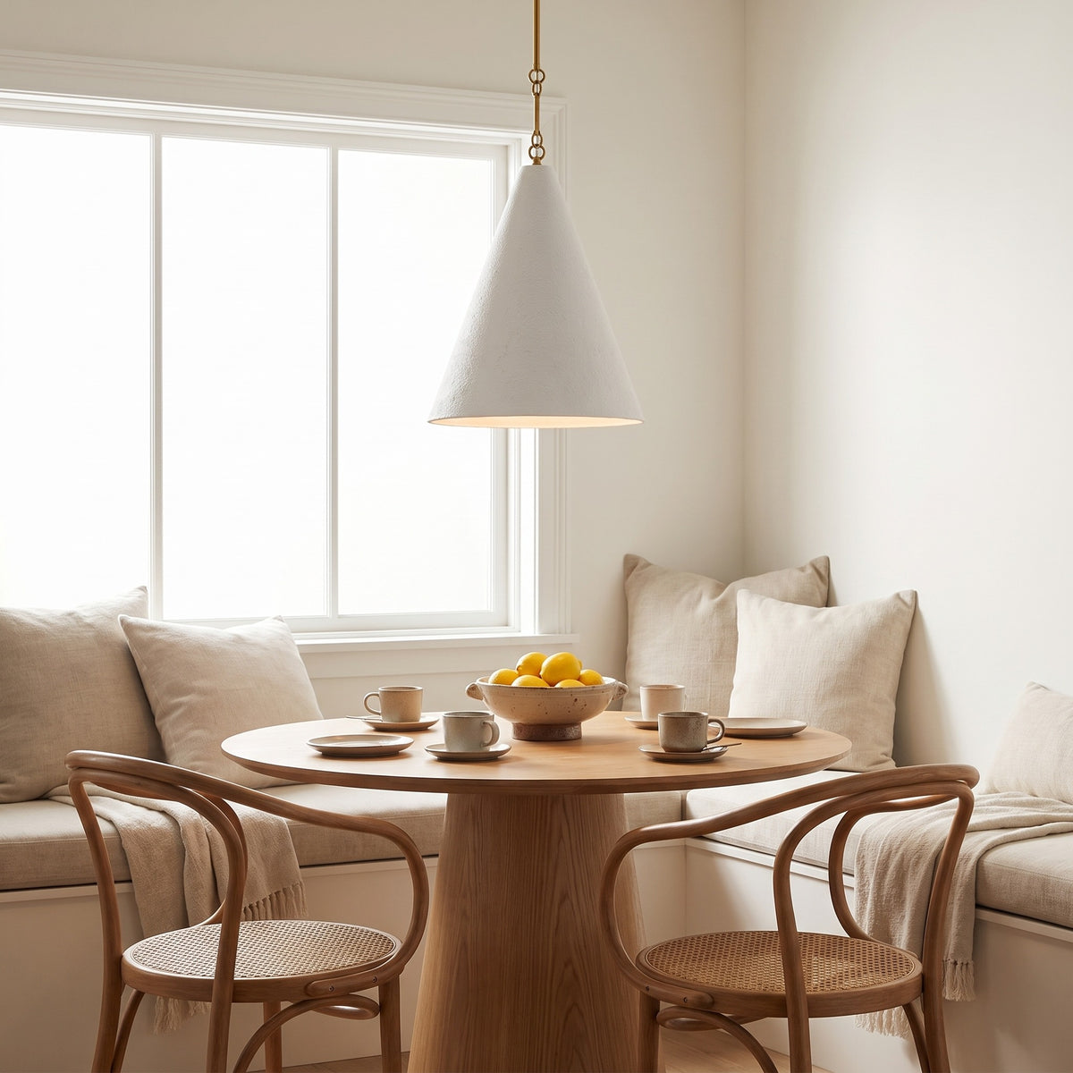 All-white Calma Gessata pendant over a round oak table in a sunlit breakfast nook