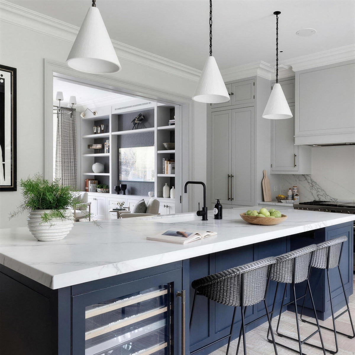 Calma Gessata plaster pendants hung at staggered heights over a kitchen island