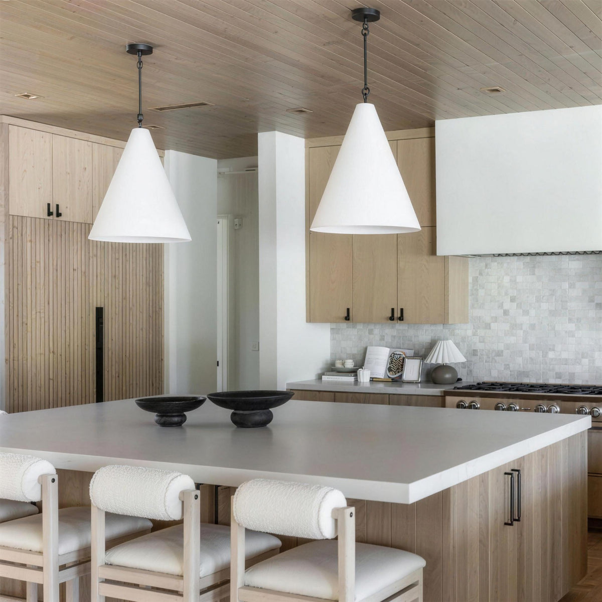 Calma Gessata plaster pendant above a villa dining table