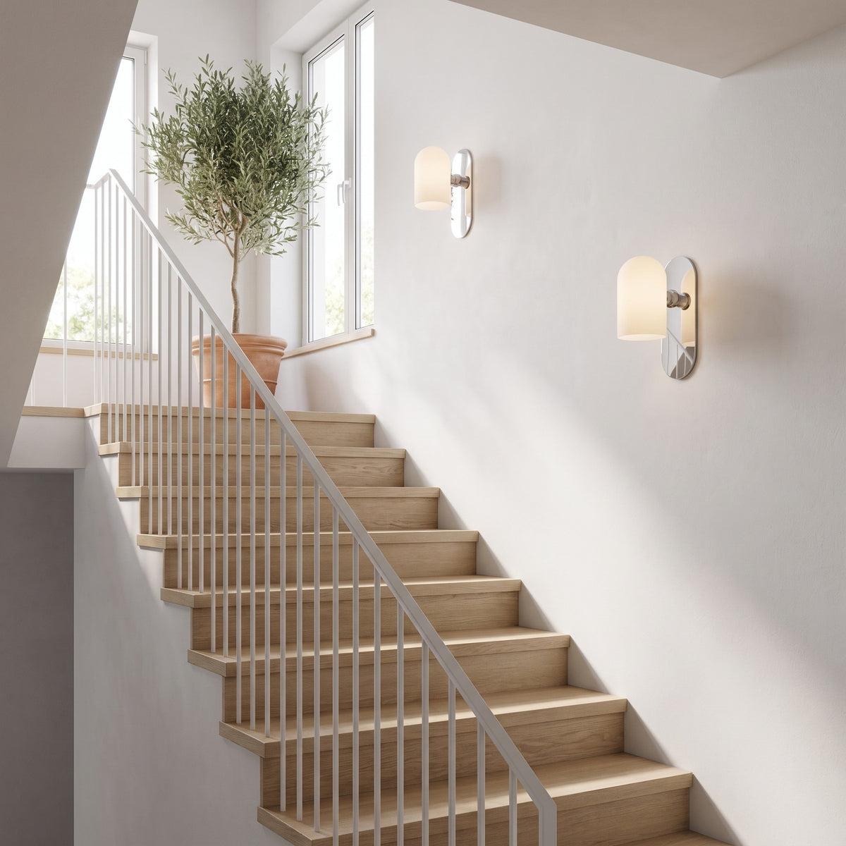 Capsula Opalina nickel wall sconces stepping up a bright oak staircase