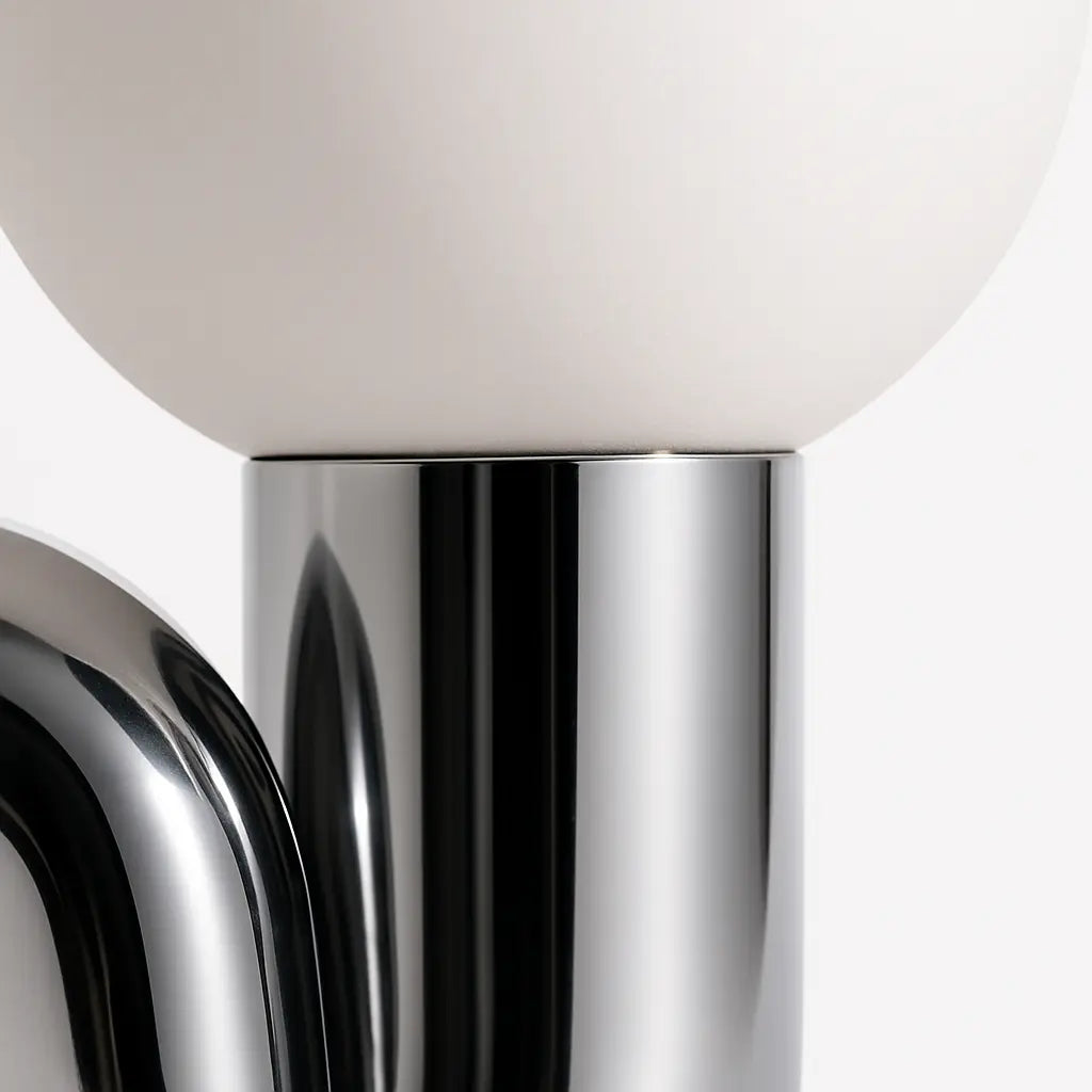 Ricciolo Lucente table lamp — frosted glass globe and chrome neck detail