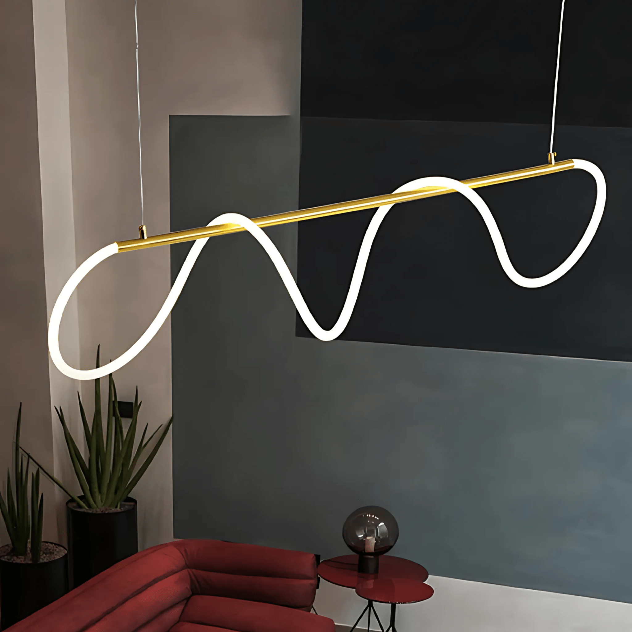 Brass Onda chandelier above a sofa in a colourful living room