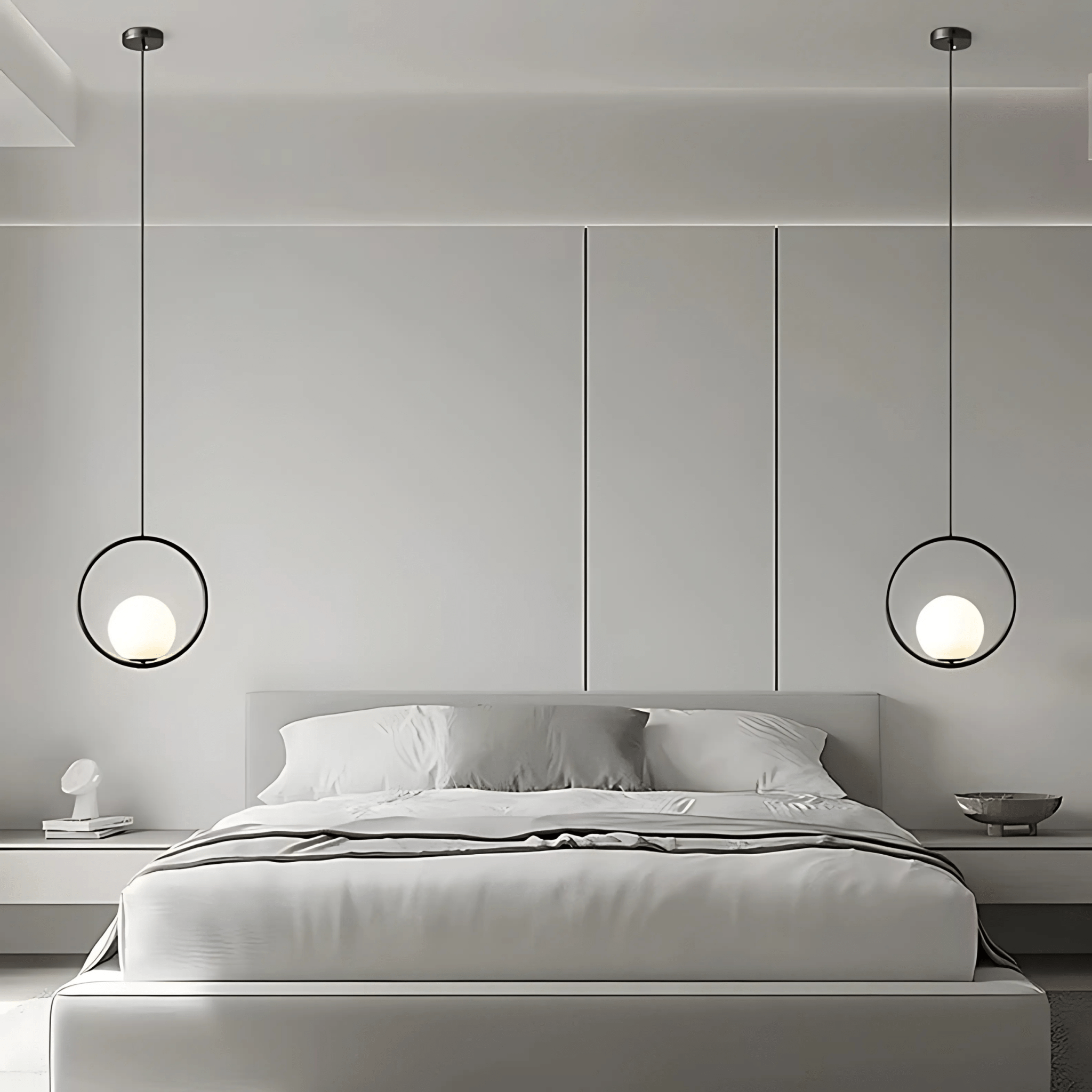 A pair of black Sfera ring glass-globe pendants flanking a bed