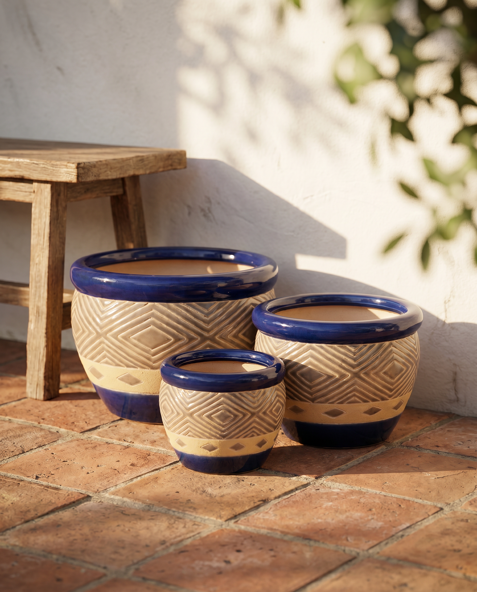 Cobalt blue ceramic planter trio styled on a sunlit Mediterranean terrace