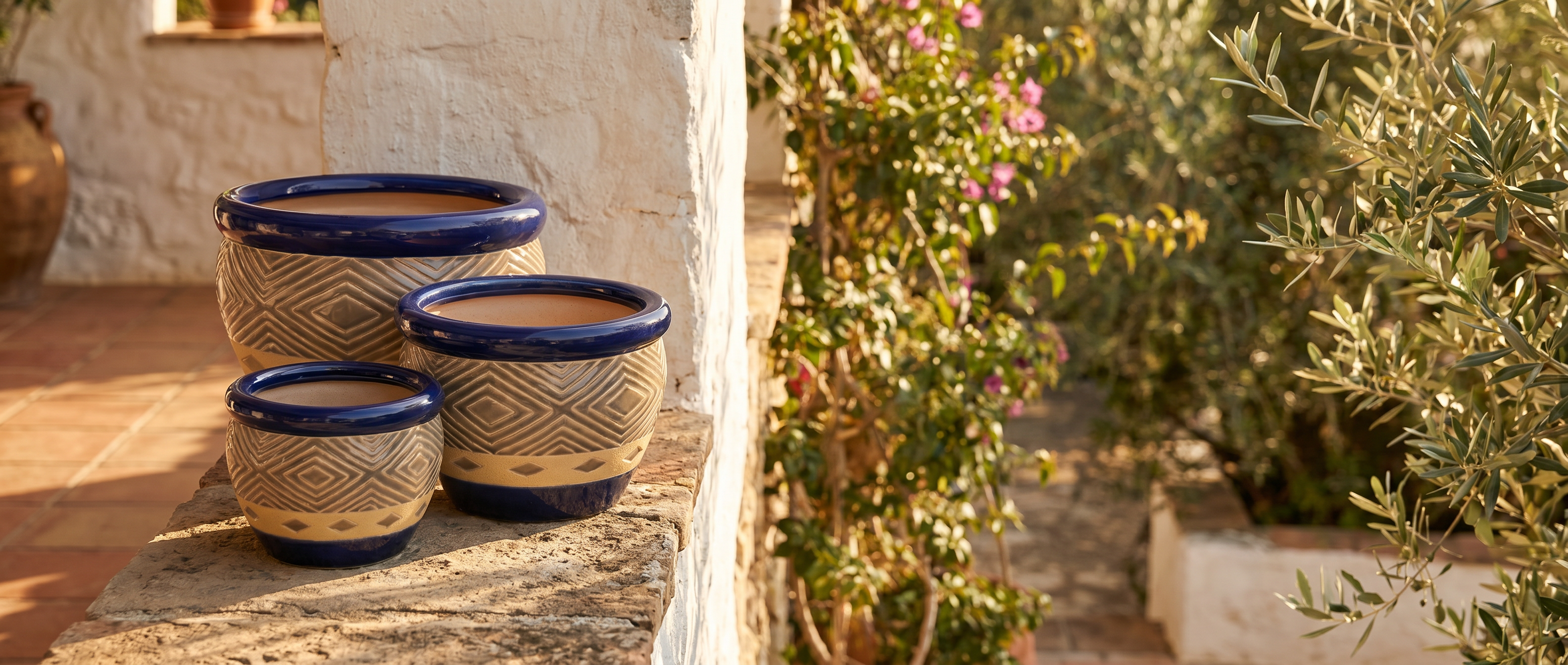 Cobalt blue ceramic planter trio on a sunlit Mediterranean veranda — banner