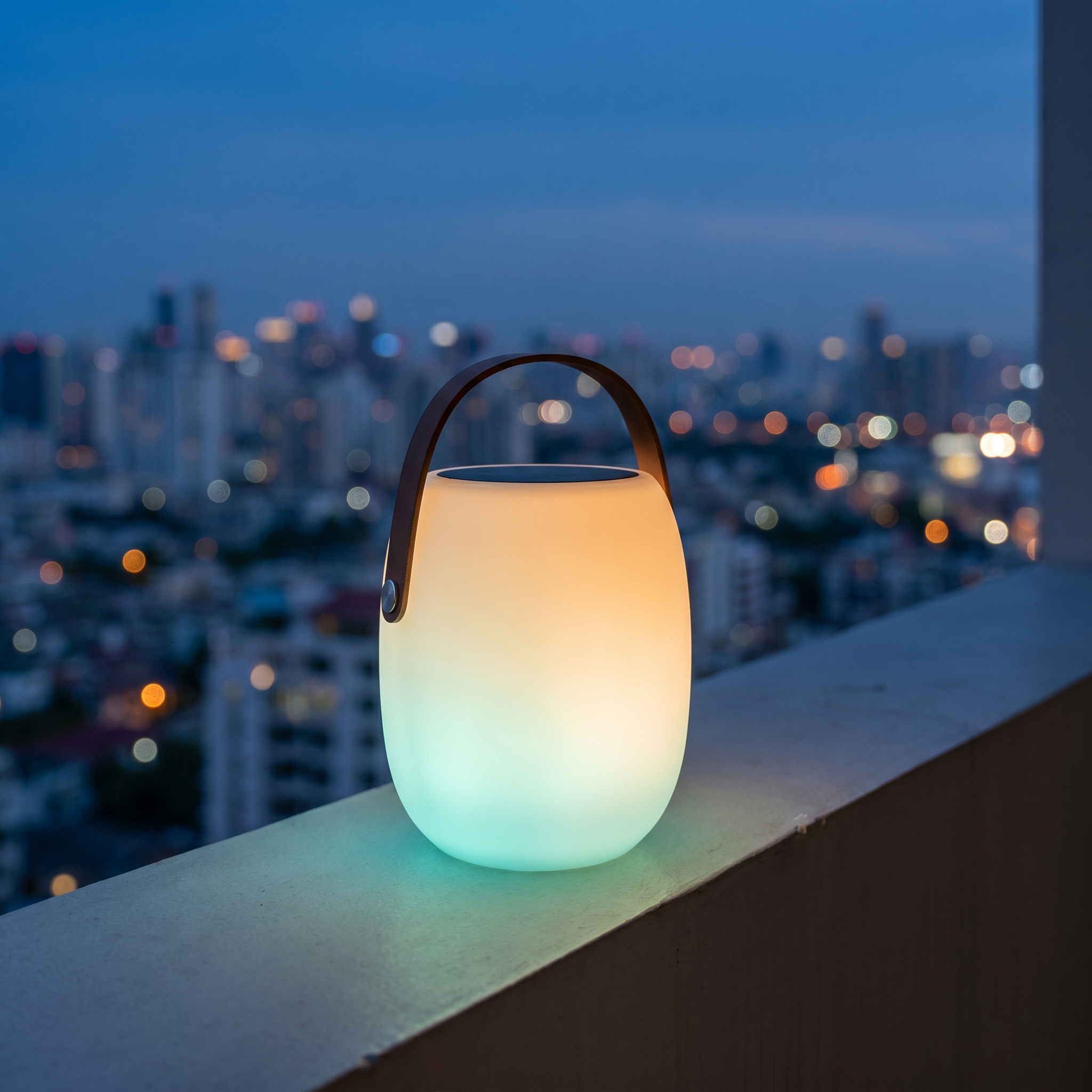 Lucciola Costiera lantern showing its color-changing glow on a balcony at blue hour