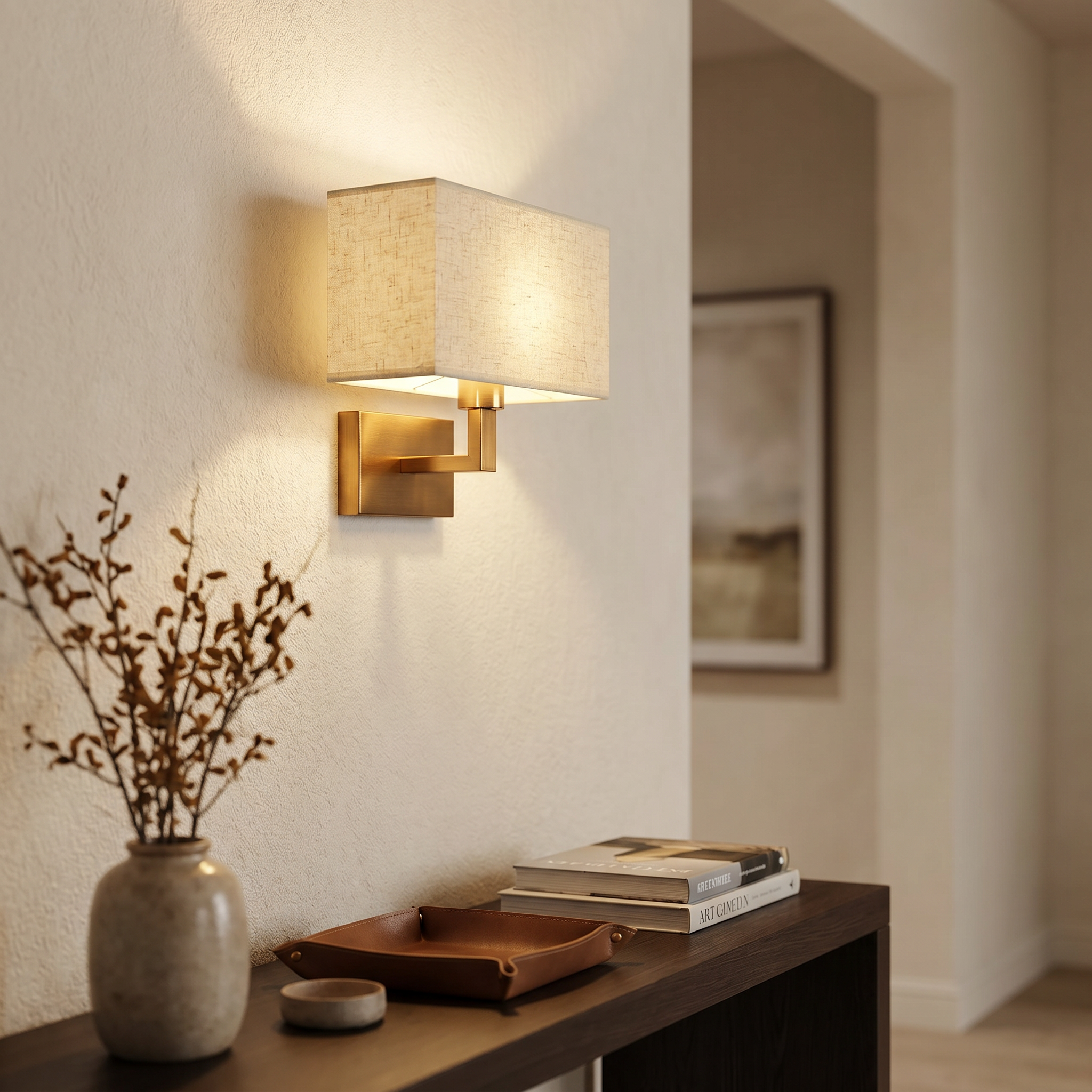 Gold and beige cuboid wall sconce above a hallway console