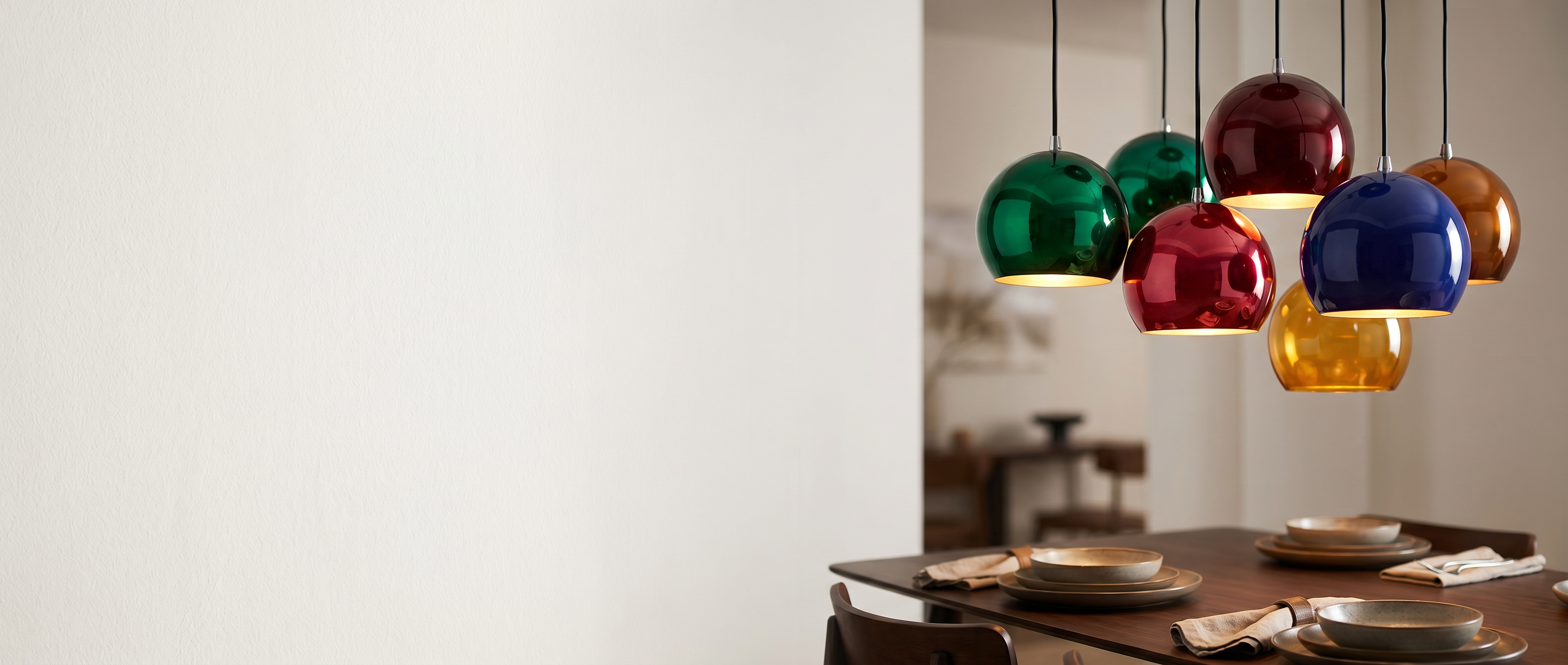 Colorful globe pendant lights over a modern dining table — Zanoro Casa