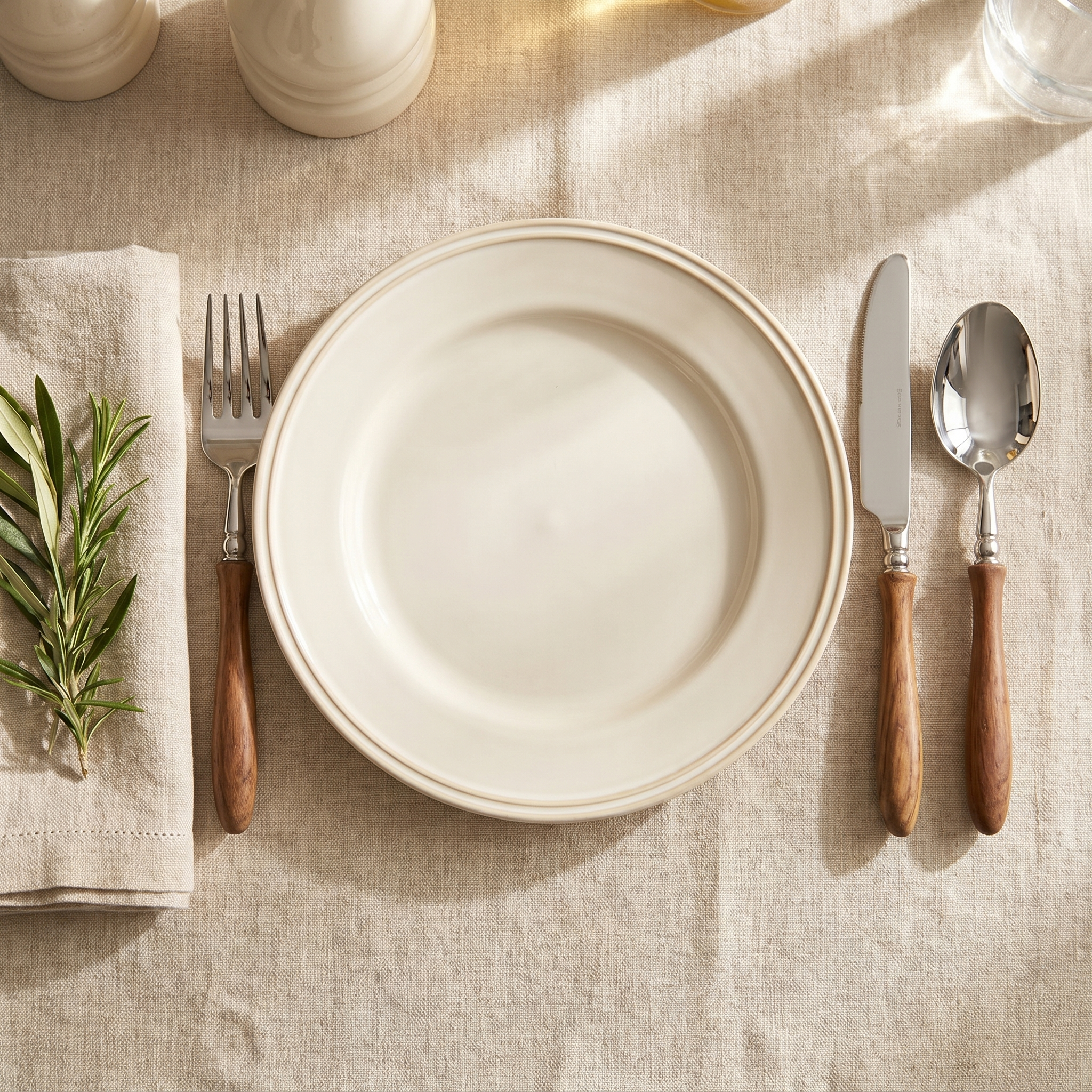 Bosco Rustico flatware in an elegant single place setting with cream plate and linen