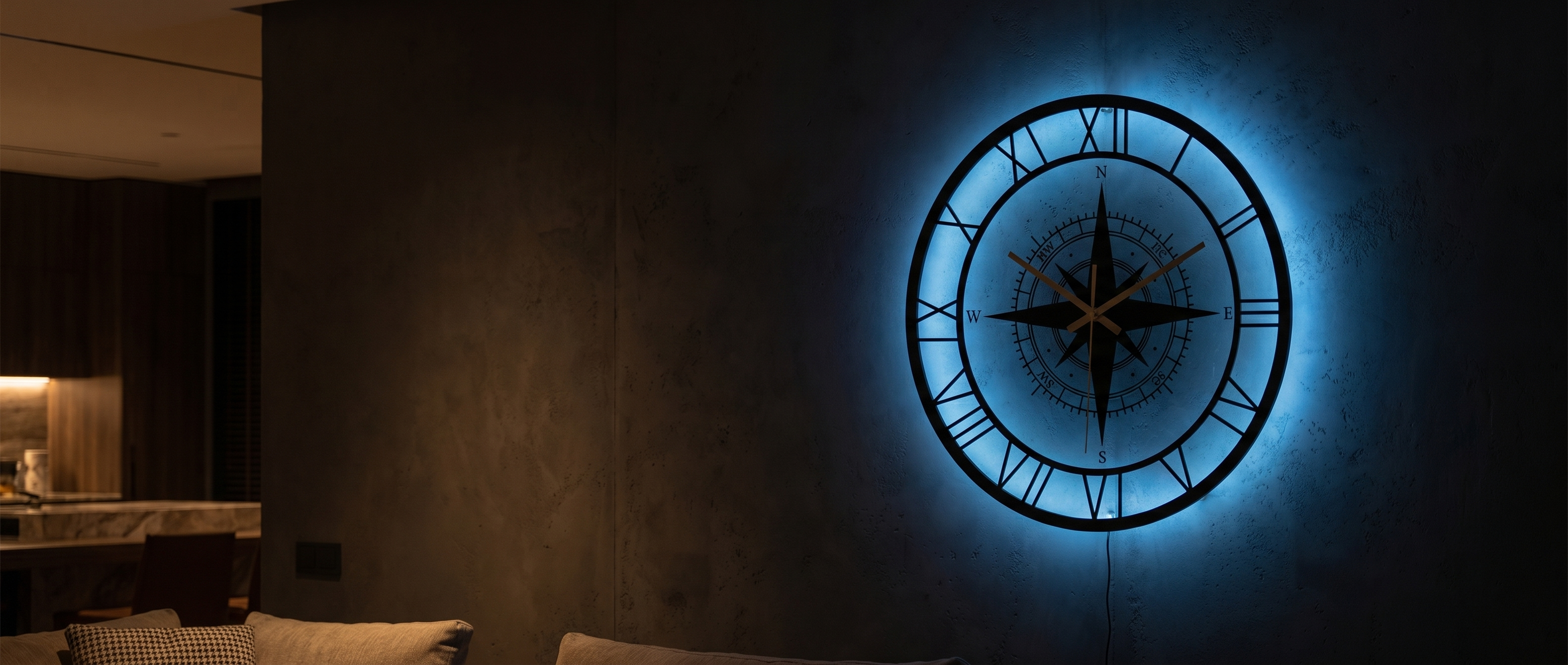 Bussola Marina nautical compass wall clock glowing ocean-blue in a dim modern living space — Zanoro Casa