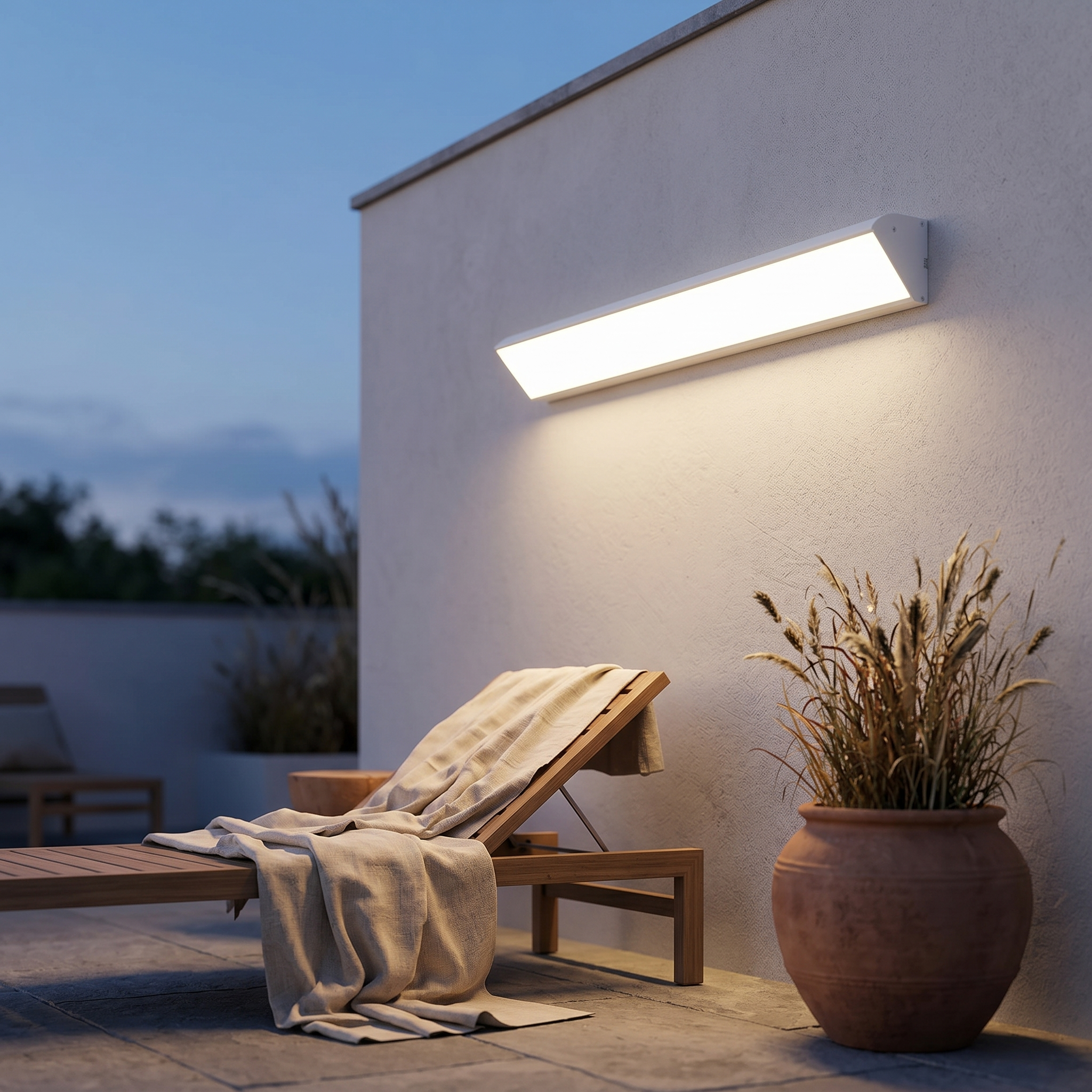 Sentinella white wall light on a contemporary patio at dusk