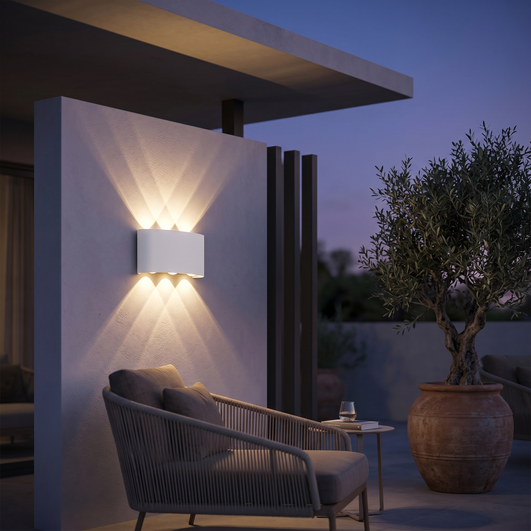 Aura Soffusa white wall light on a contemporary patio at dusk