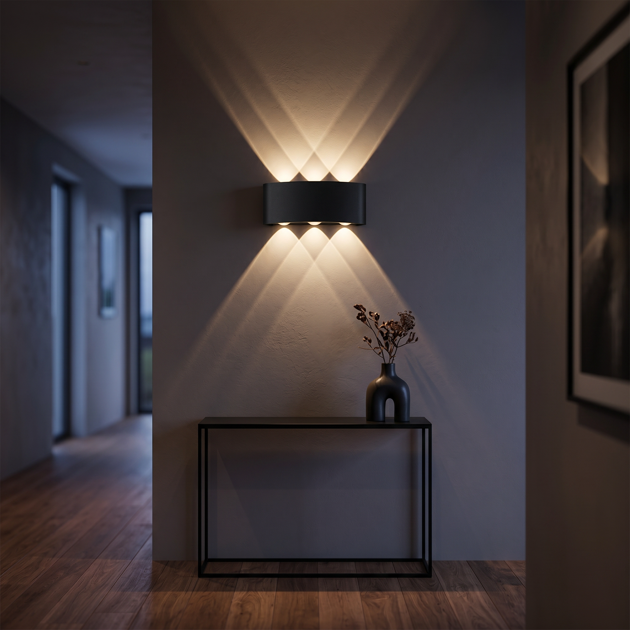 Aura Soffusa black wall light with warm beams in an elegant hallway