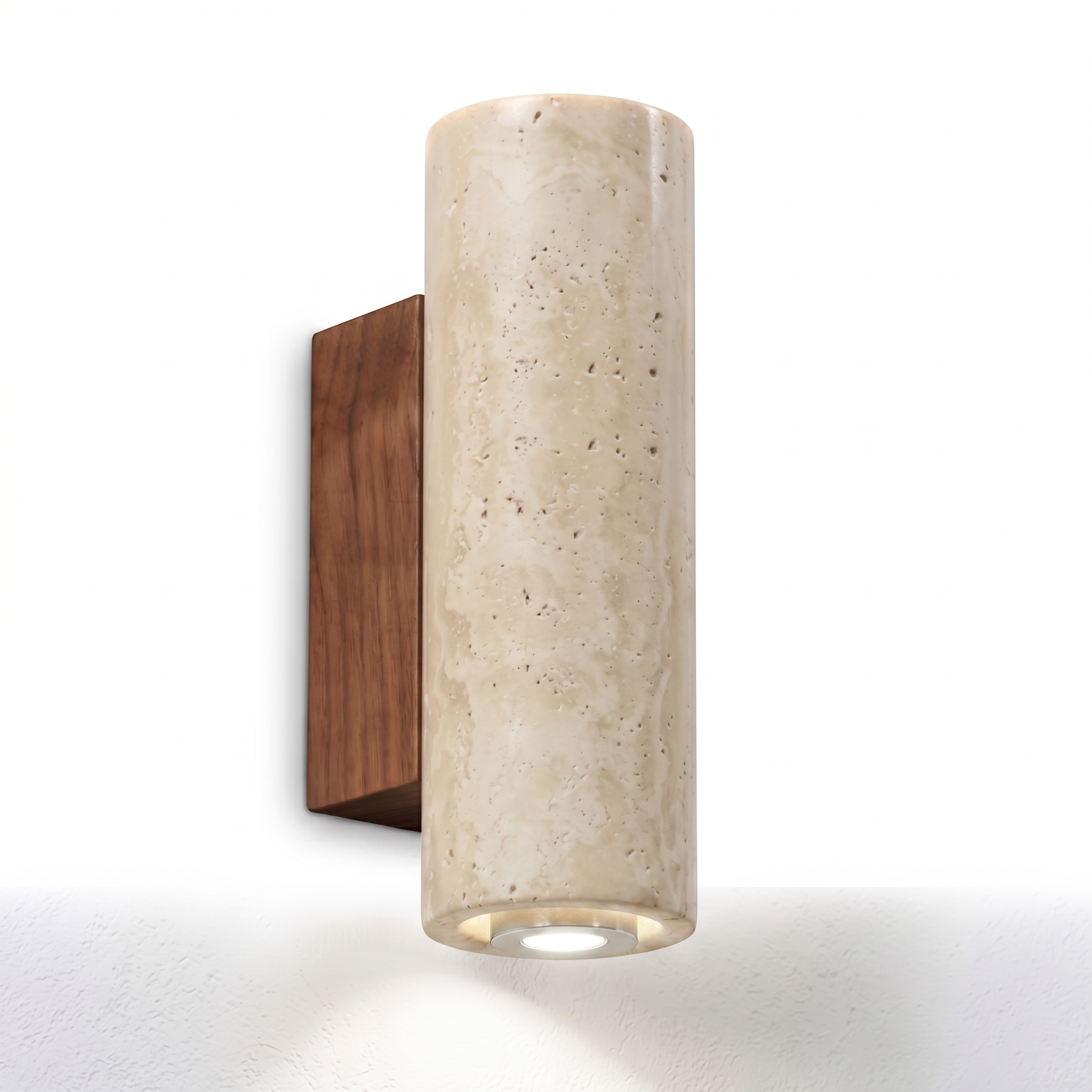 Luce di Pietra travertine wall sconce with neutral white glow on a white background