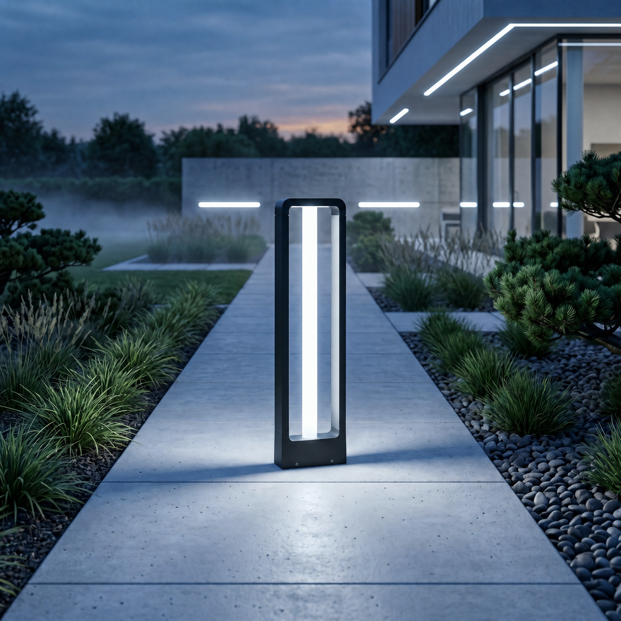Black bollard path light with cool white glow in a contemporary landscaped garden