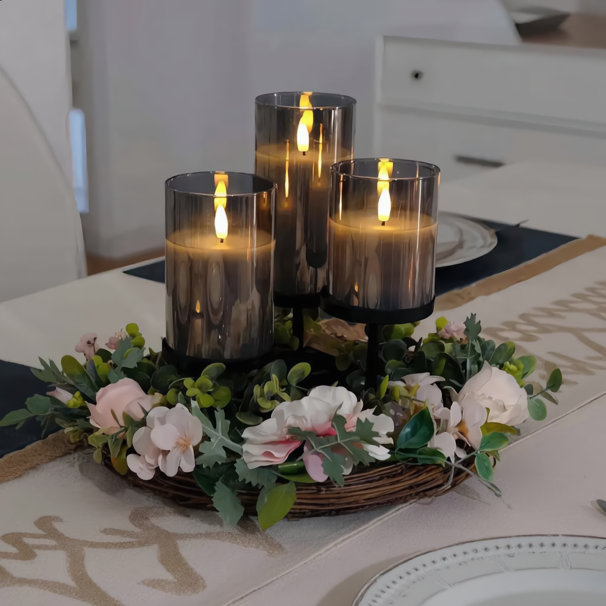 Black glass Fiamma Serena flameless candles as a dining table centerpiece with a floral wreath