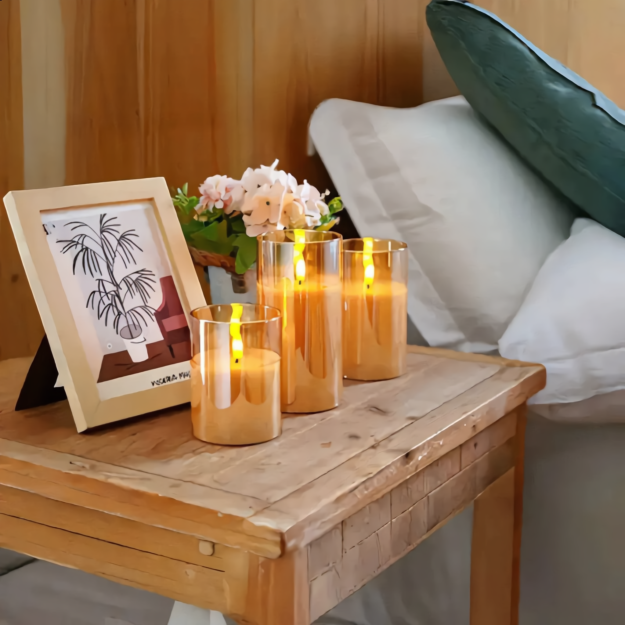 Amber glass Fiamma Serena flameless candles on a cozy wooden bedside nightstand