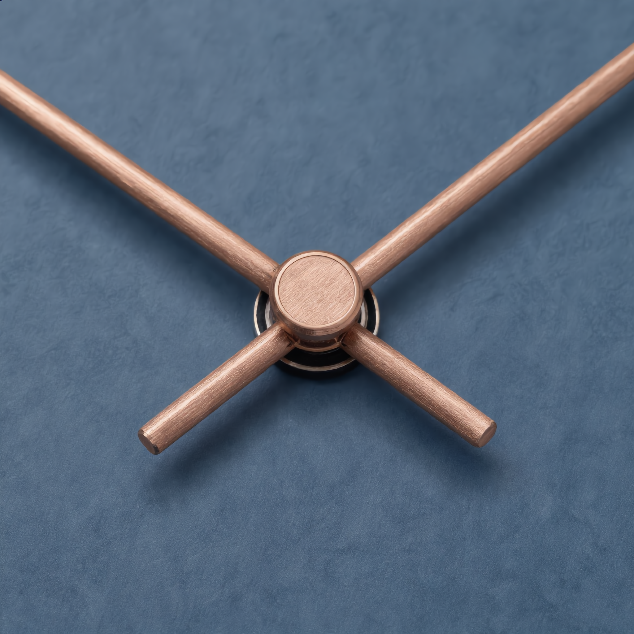Macro detail of the copper hands and matte wood face of the Silenzio clock