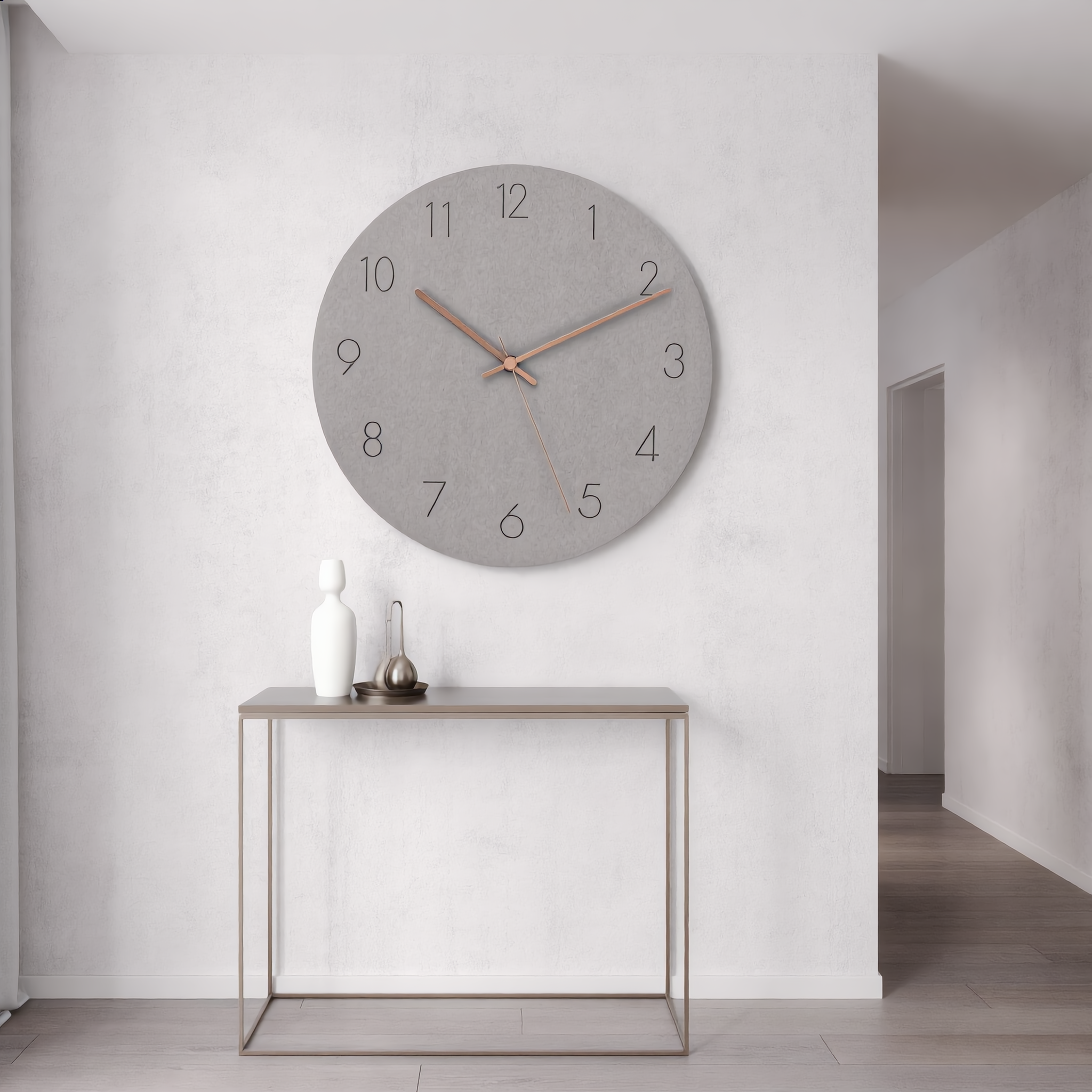 Gray Silenzio wall clock in a minimalist entryway above a console