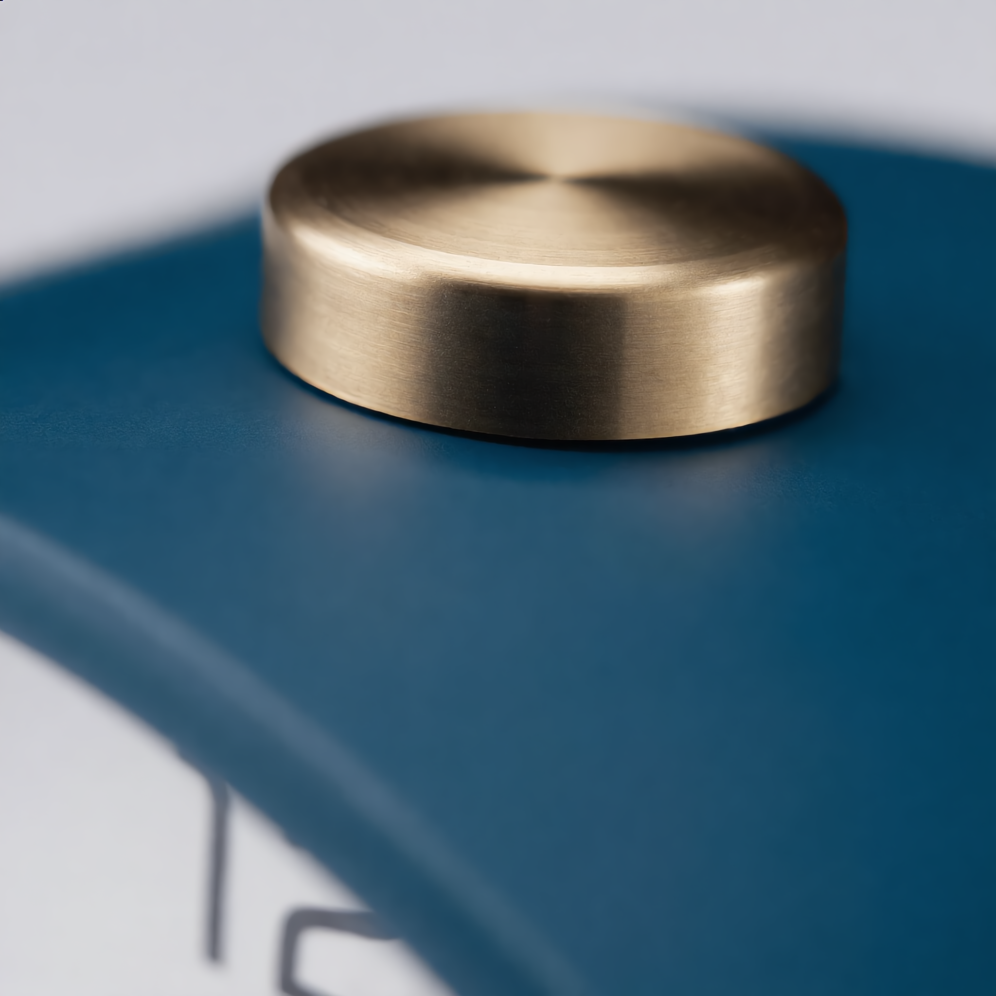 Close-up of the Serena clock brushed-brass crown on top