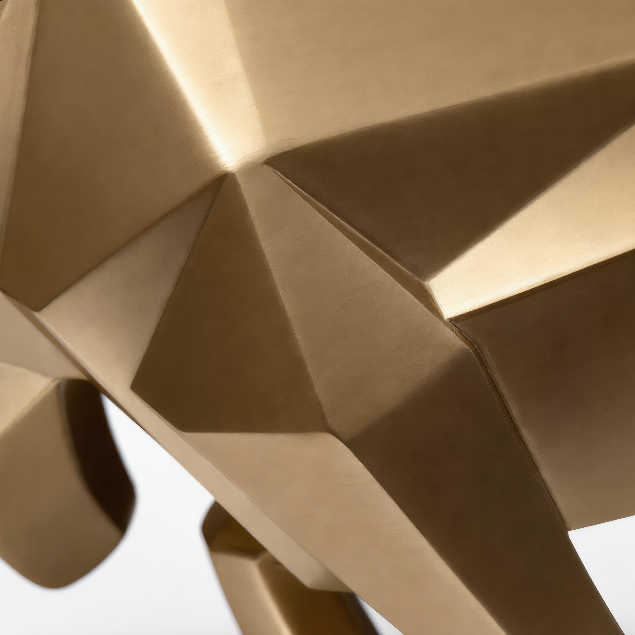 Close-up of the gold bull's geometric facets