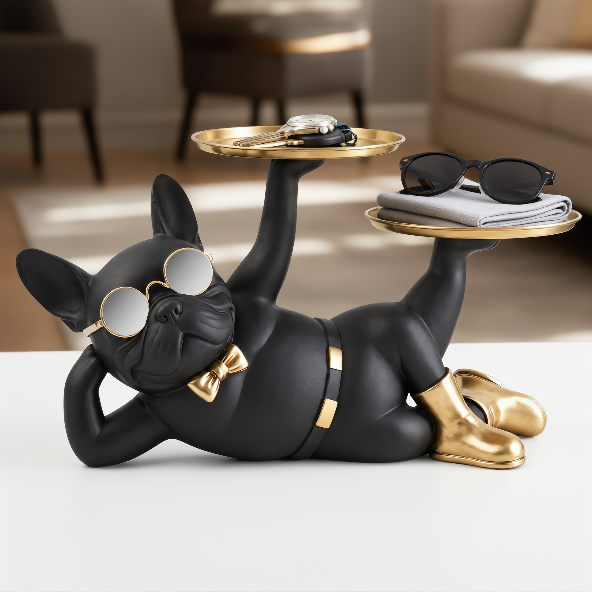 Close-up of two gold trays holding keys, watch and sunglasses