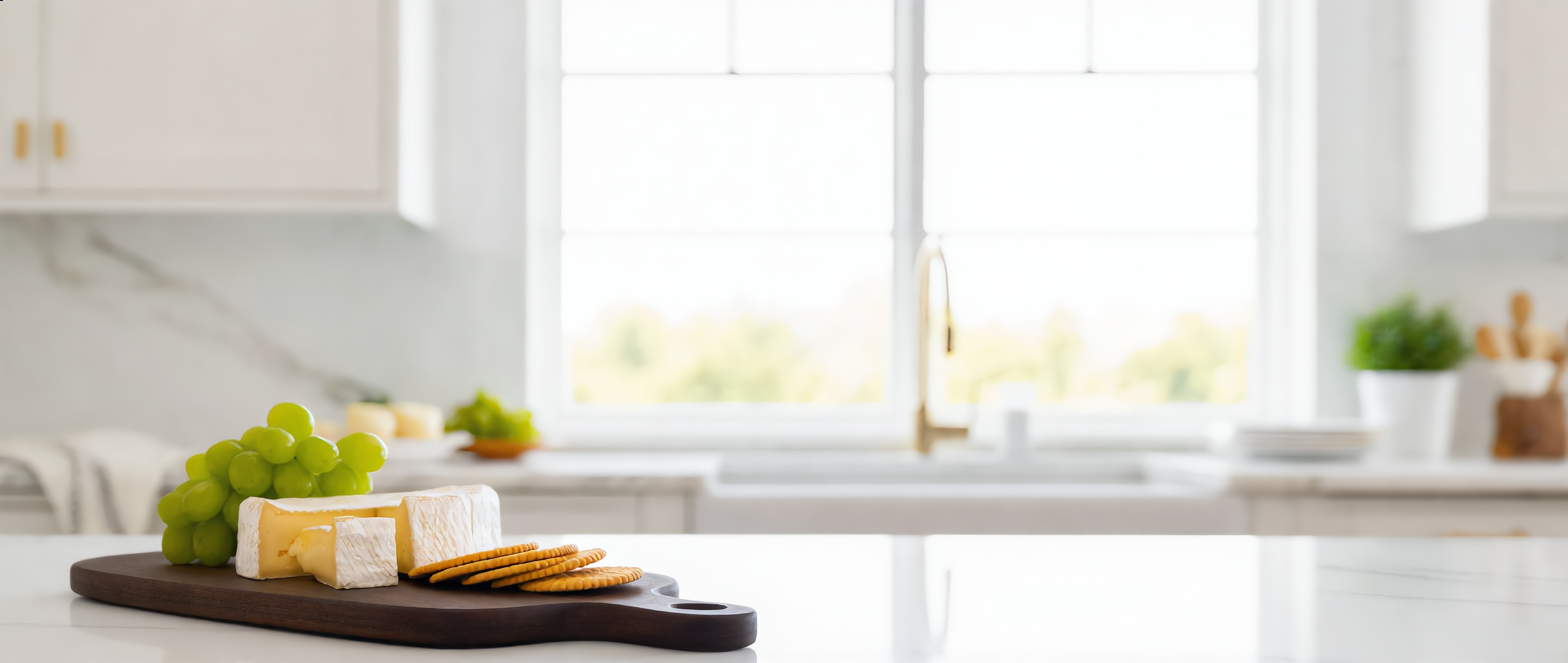 Conviva walnut serving board with charcuterie in a bright kitchen