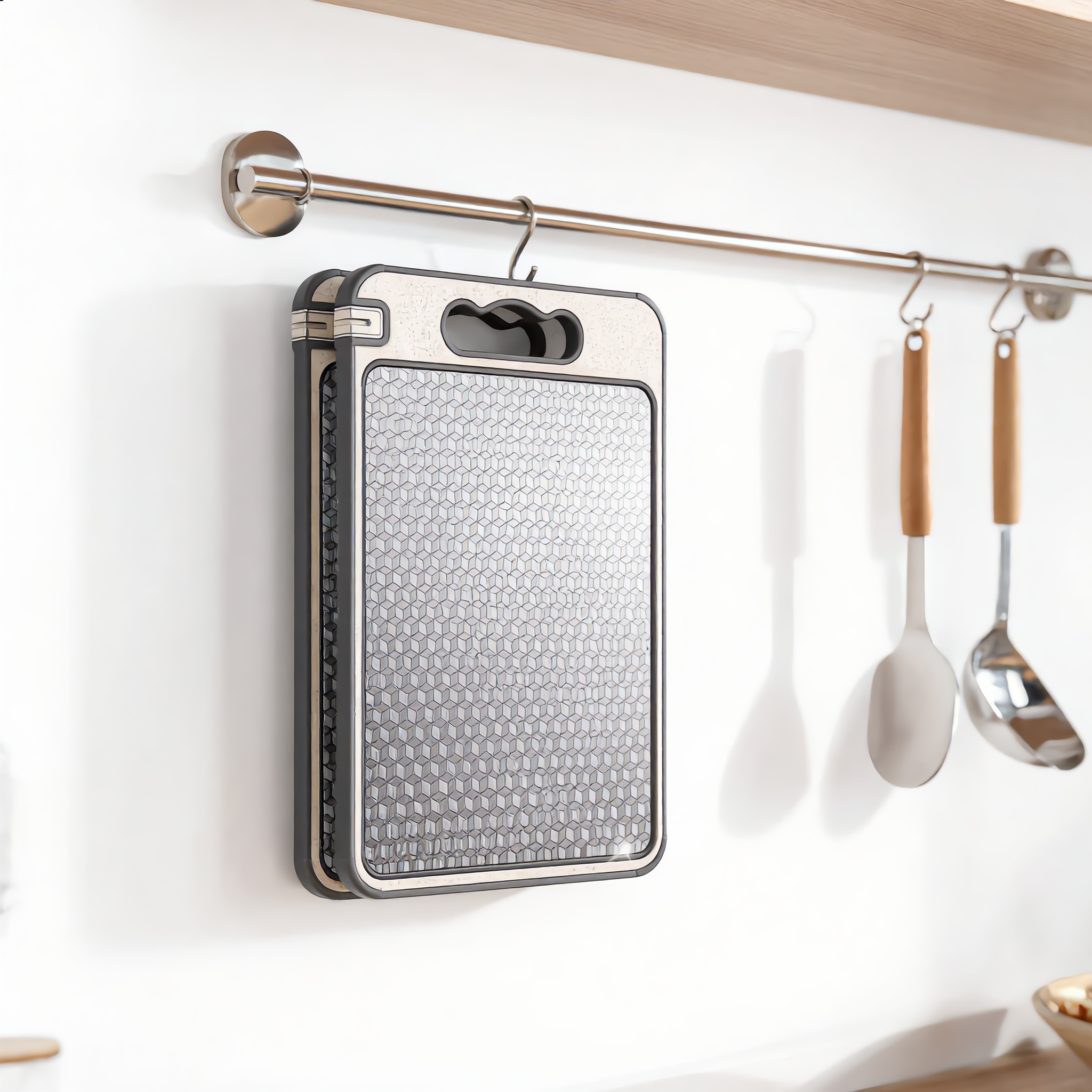 Board hanging from a kitchen rail by its handle cut-out