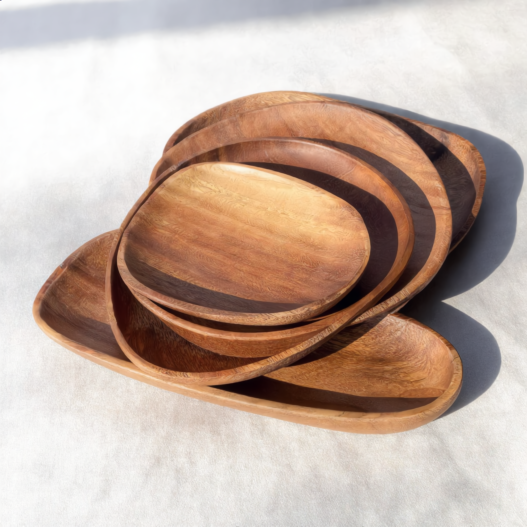 The five acacia trays showing graduated sizes