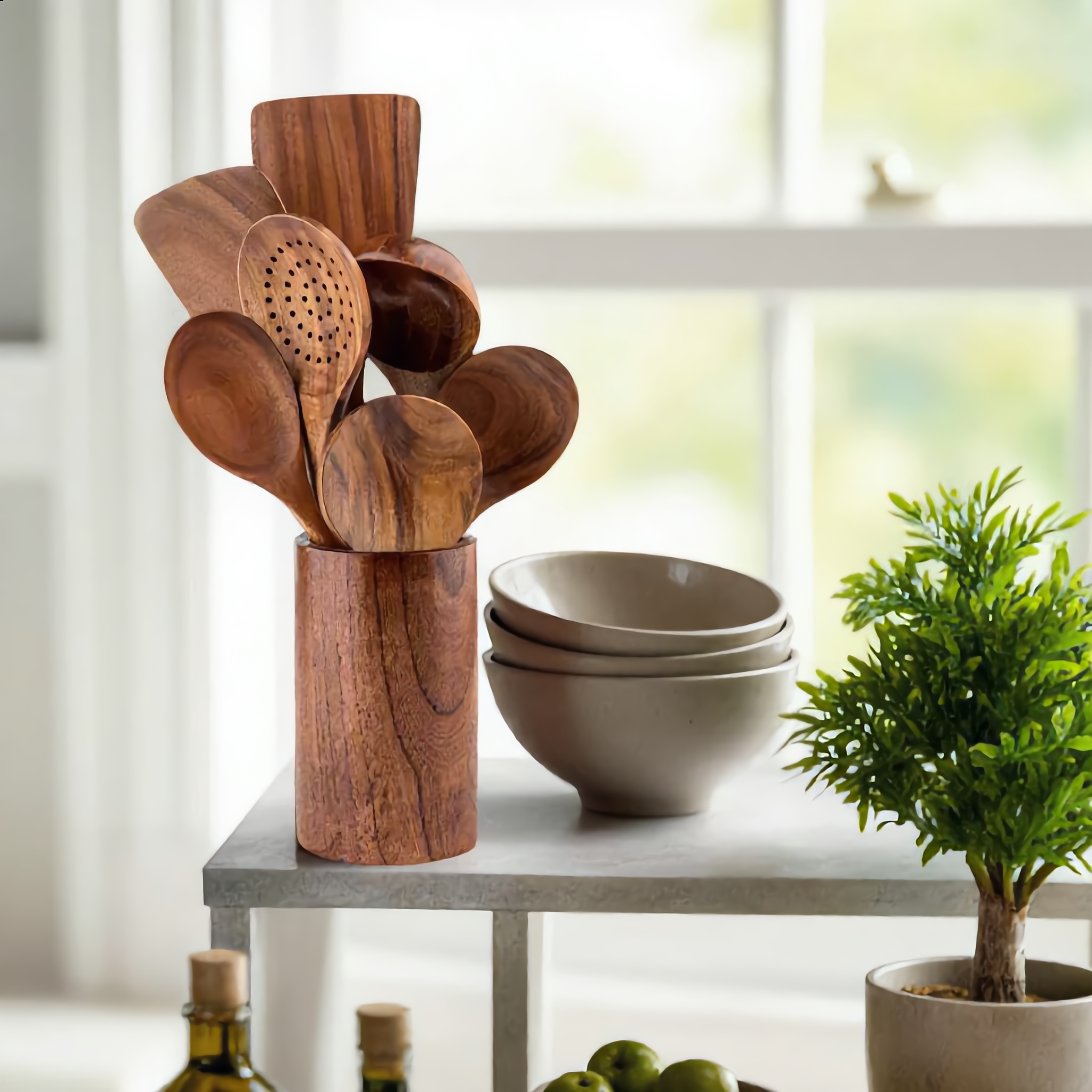Teak utensils in their holder styled on an open kitchen shelf
