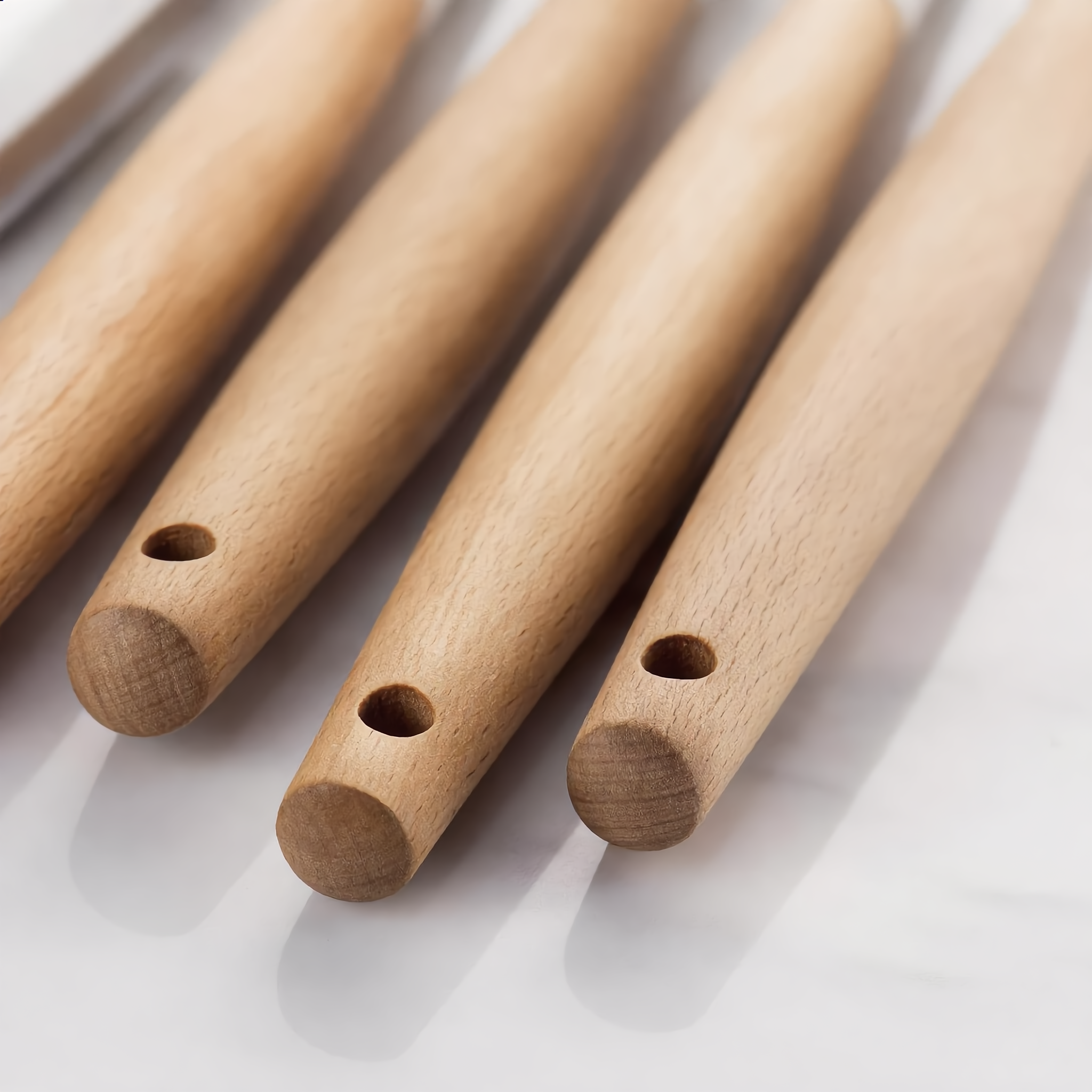Macro of the wooden handle ends with hanging holes