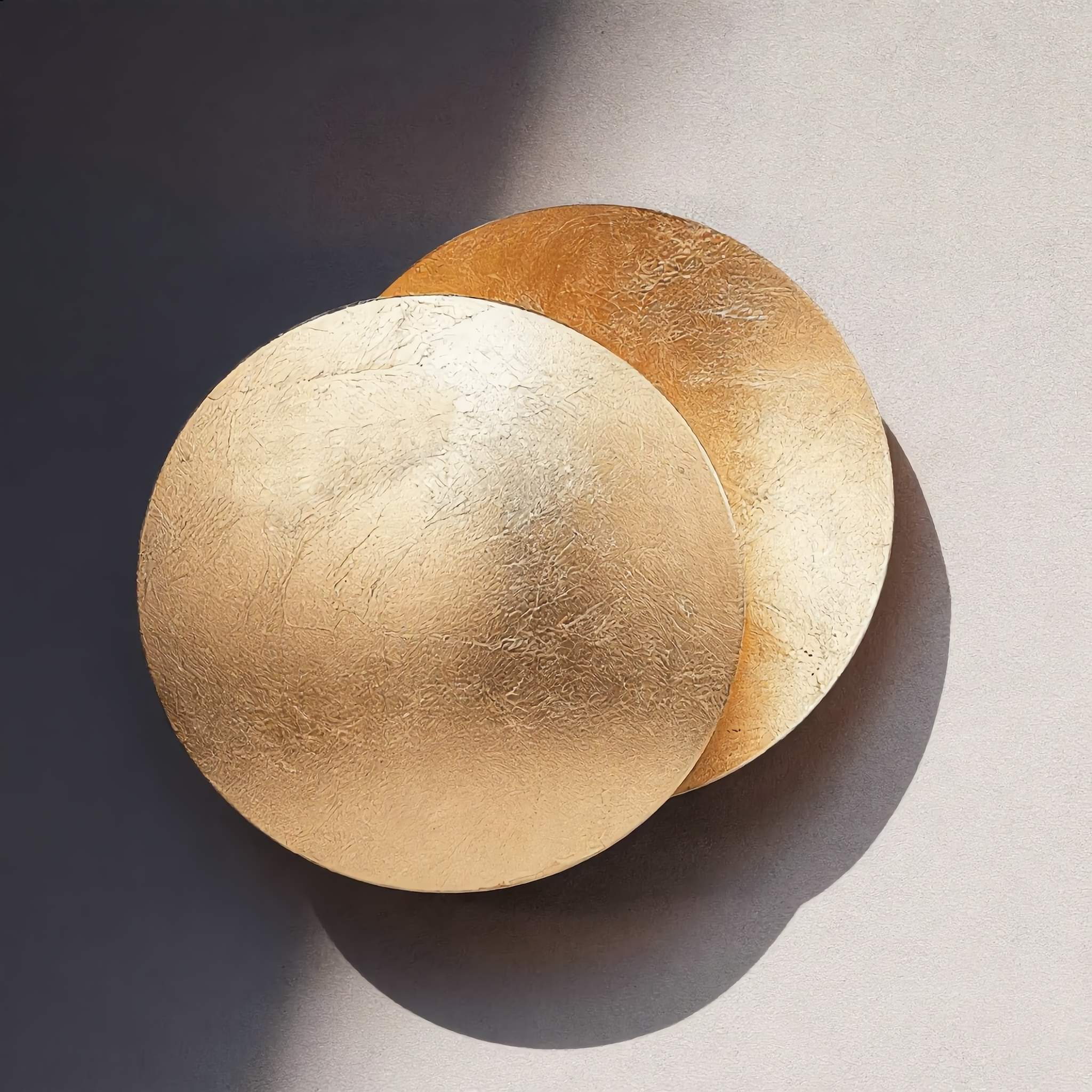 Eclissi wall sconce warm crescent glow close-up, gold leaf texture