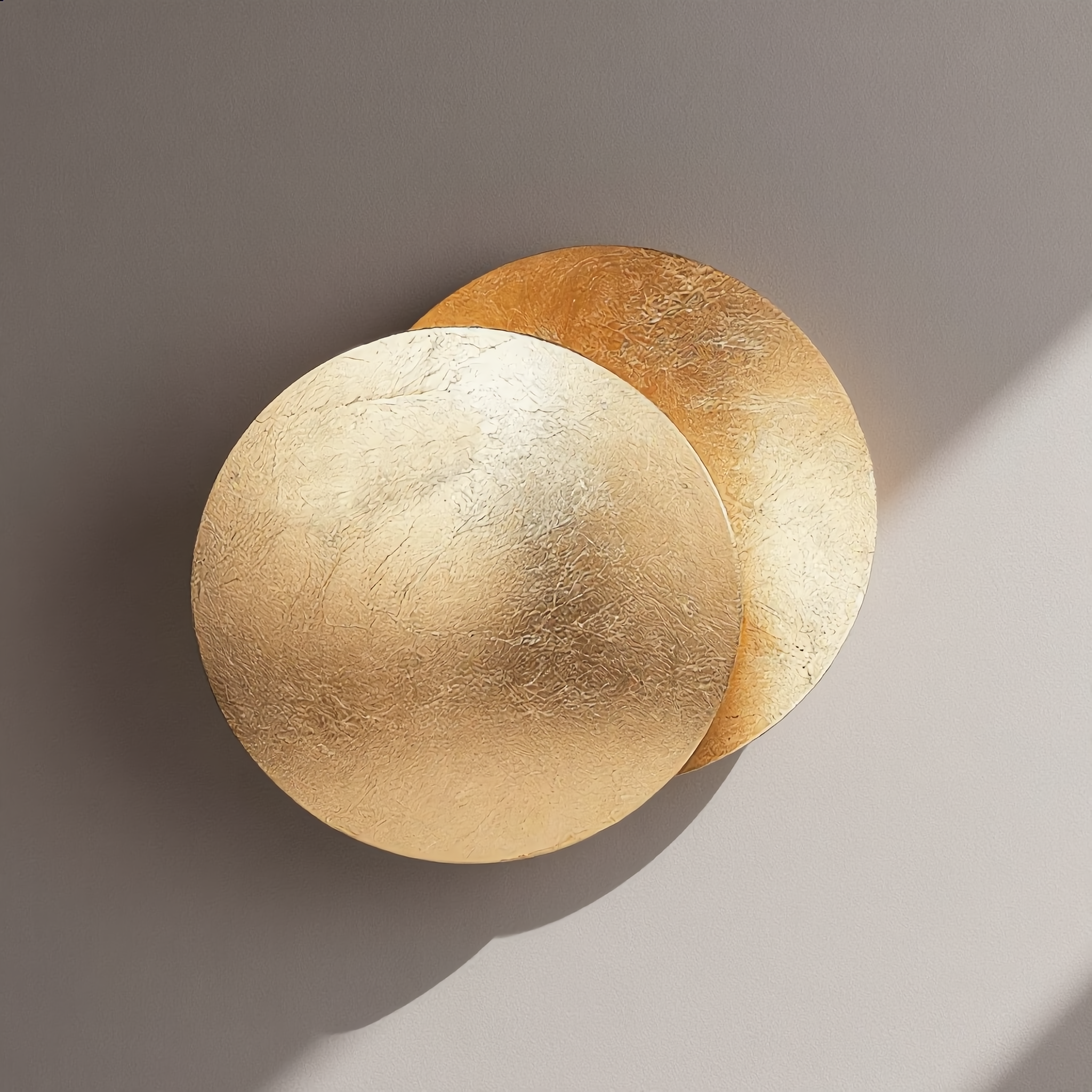 Eclissi wall sconce with neutral white 4000K glow on a bright wall