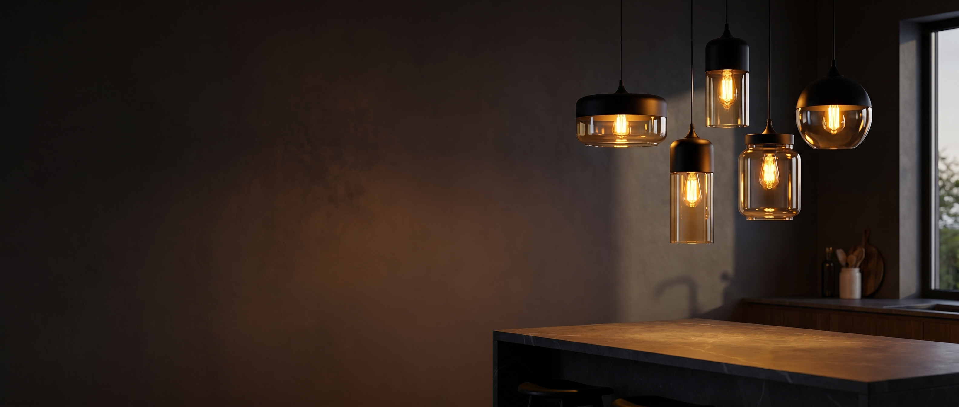 Ambra Art-Glass Pendants glowing warm amber over a kitchen island at dusk
